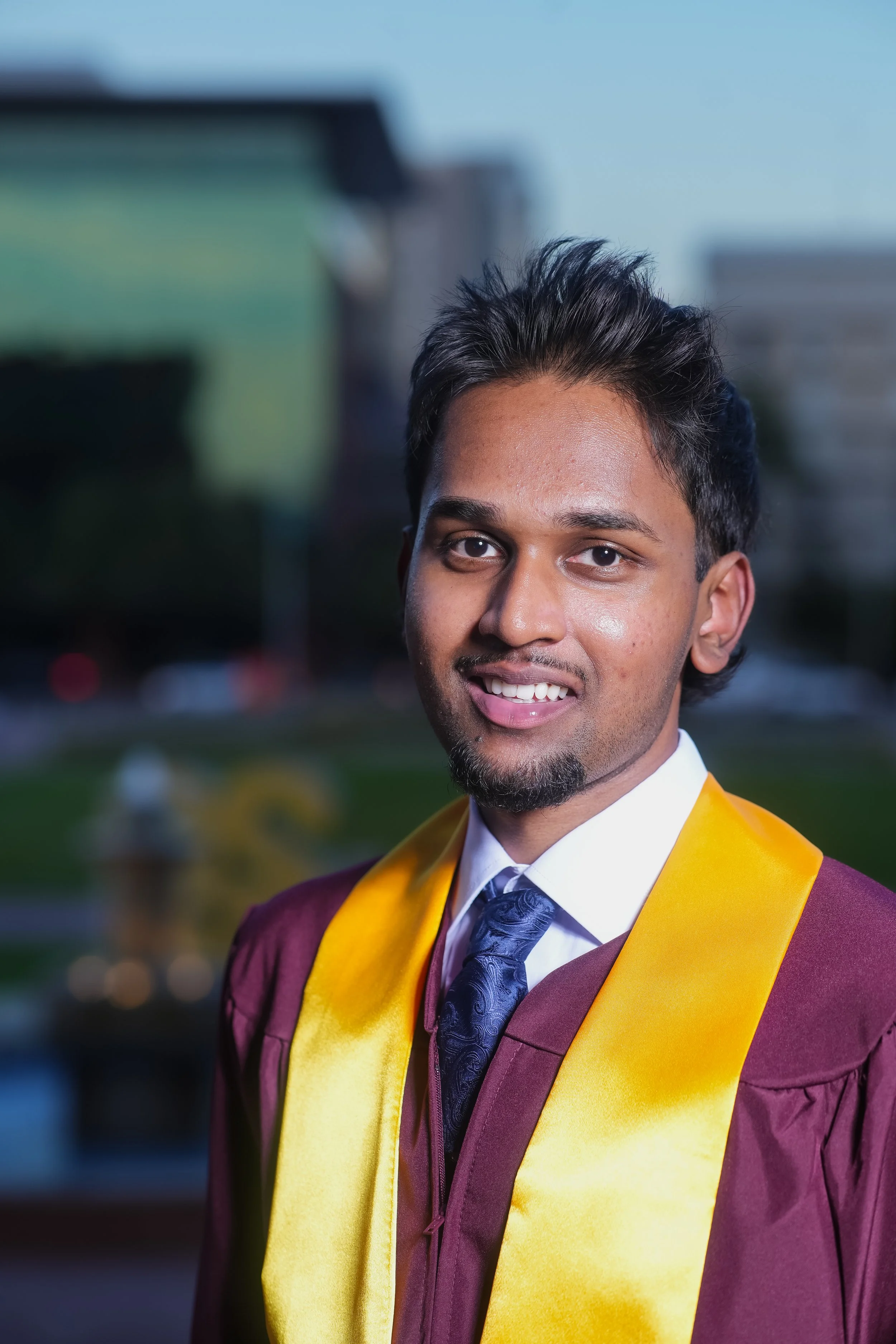 Male Arizona State Graduate climbing a horse