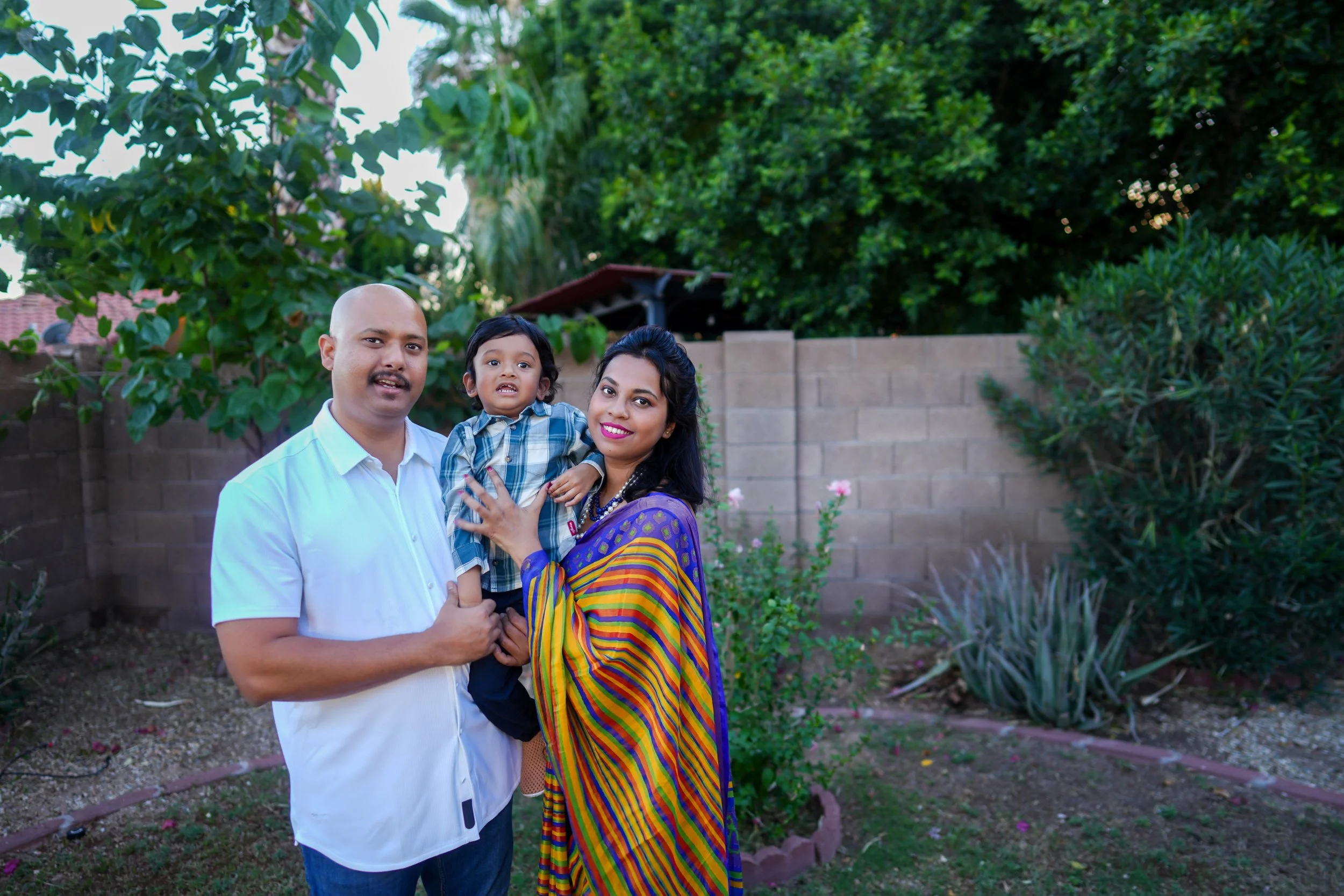 Family photo in front of a garden