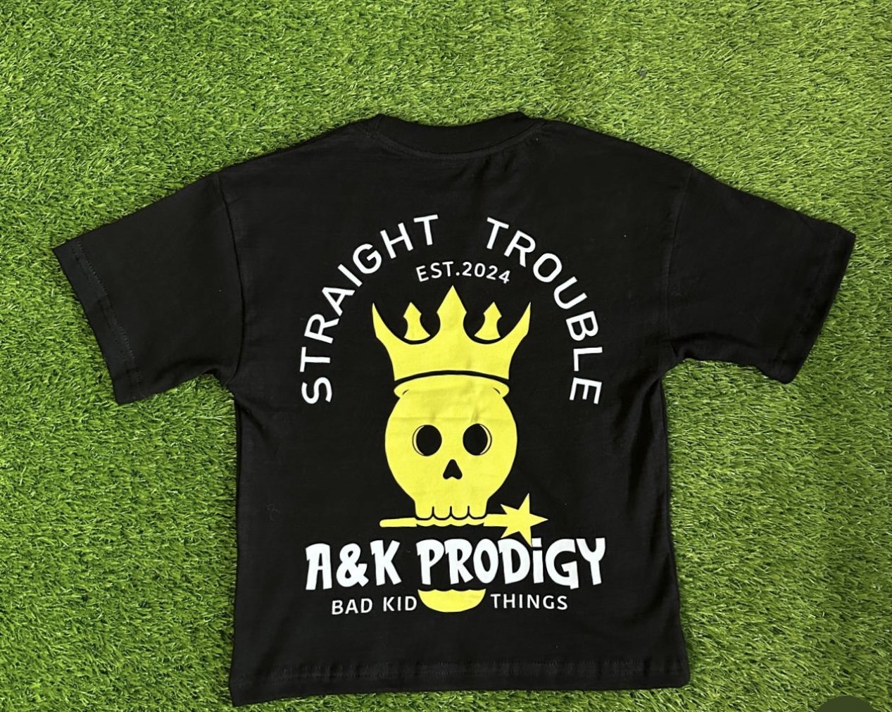Straight Trouble black tee with neon skull and headphones.