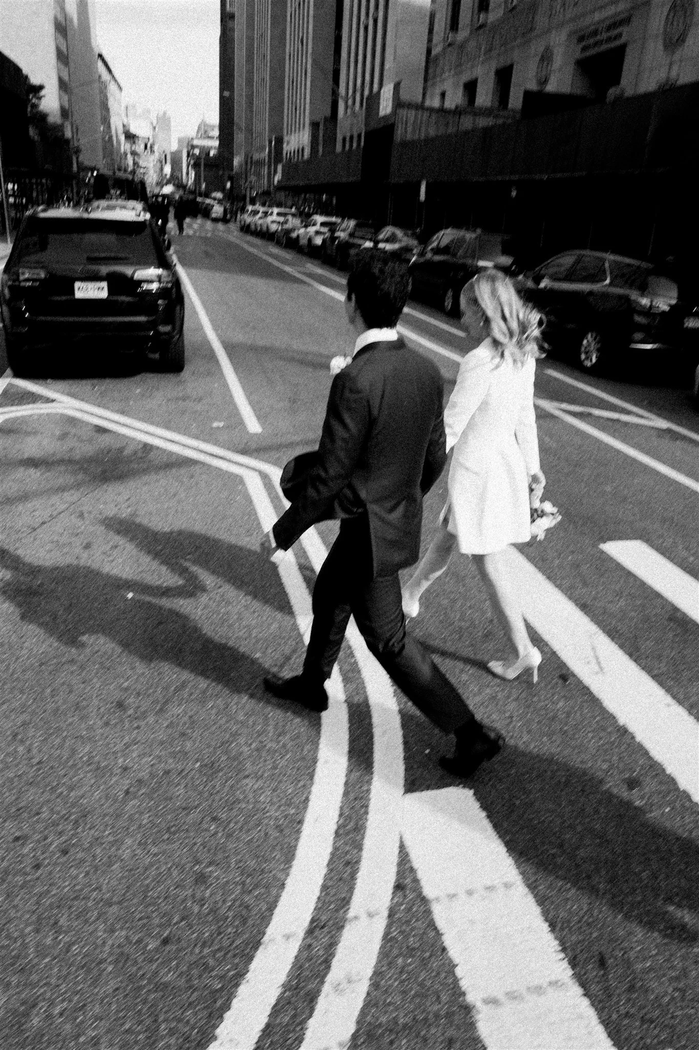 Motion photo of the couple crossing a Manhattan street in black and white. the plaza hotel nyc luxury wedding.