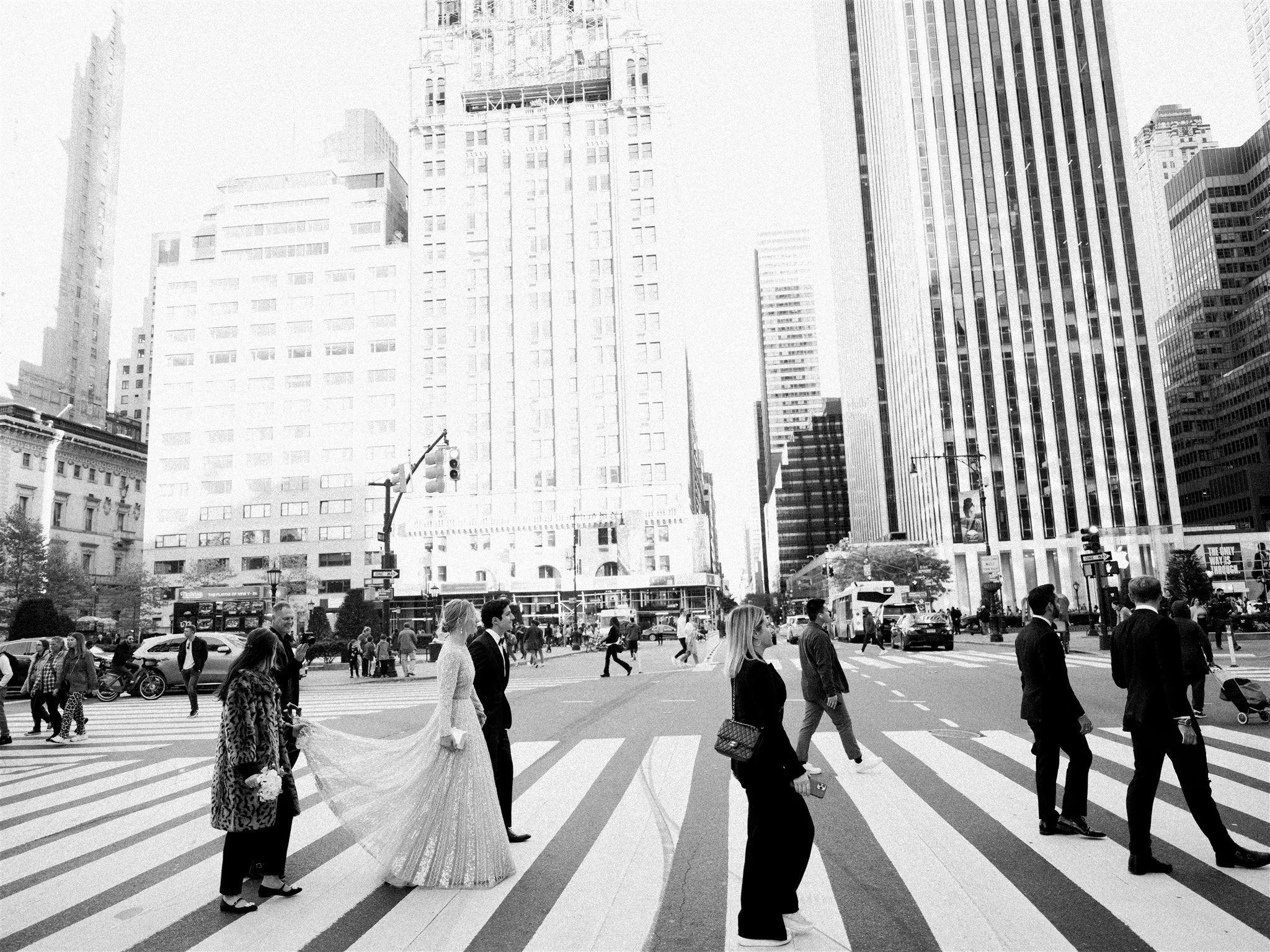 The couple crosses a busy Manhattan intersection together. new york city luxury wedding photographer.