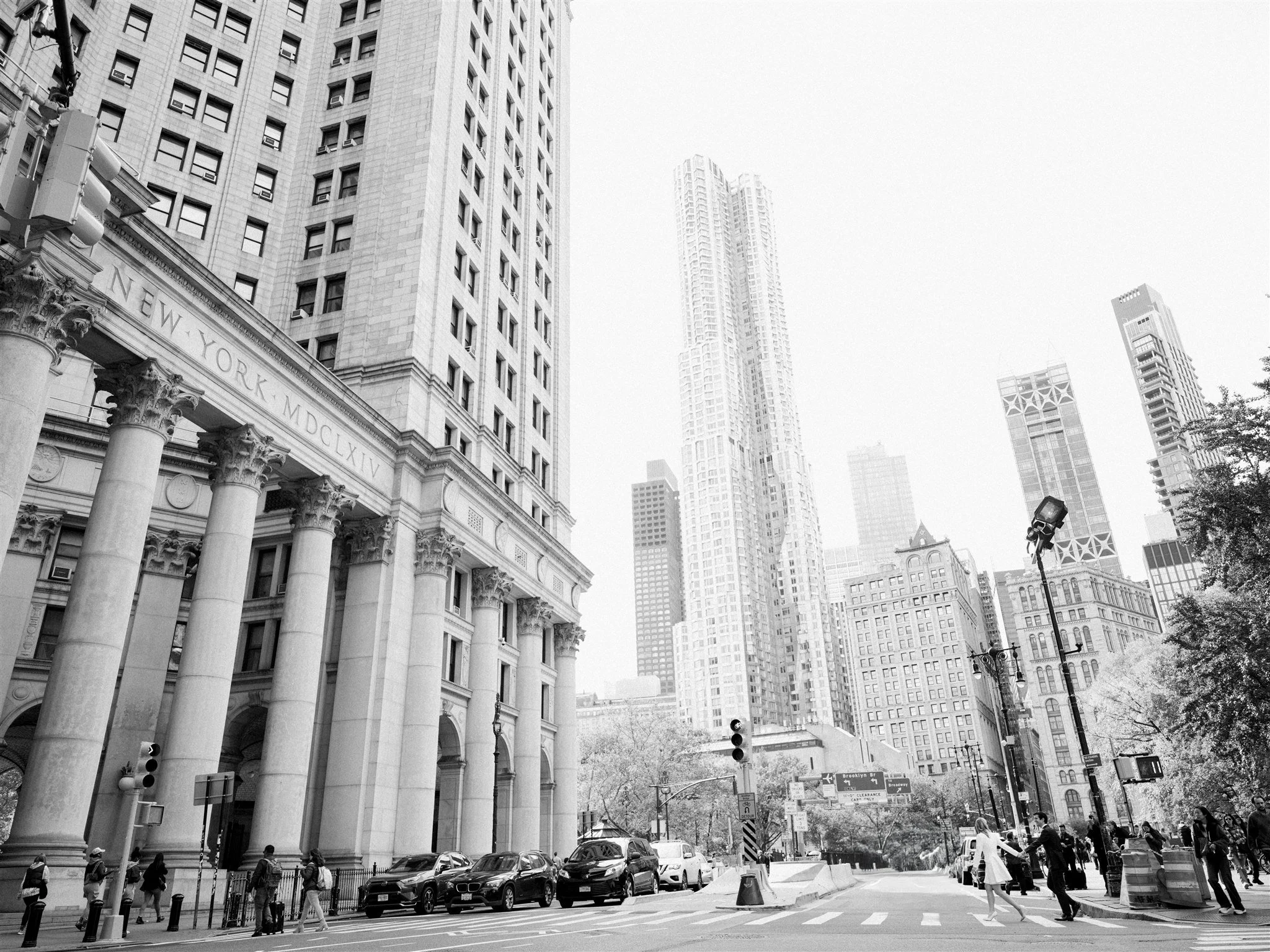 The couple crosses Centre Street with grand columns in the background. new york city editorial wedding.