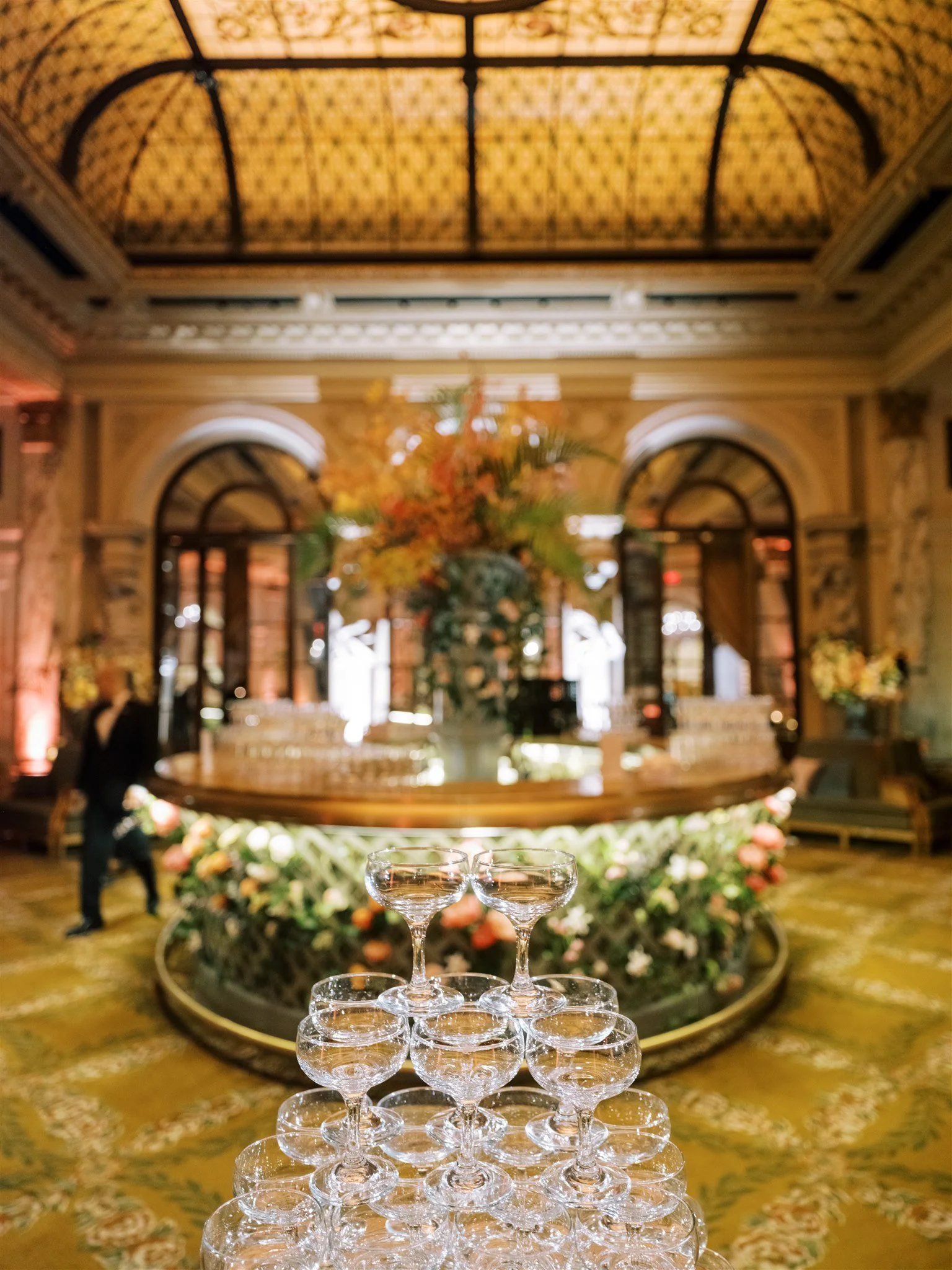 Champagne tower display sparkling in a grand ballroom. manhattan wedding photographer new york.