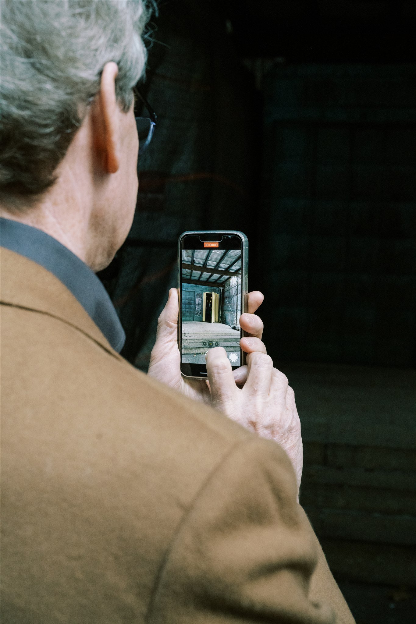 Father lifts his phone to film the courthouse steps as the couple exits. the plaza hotel nyc luxury wedding.