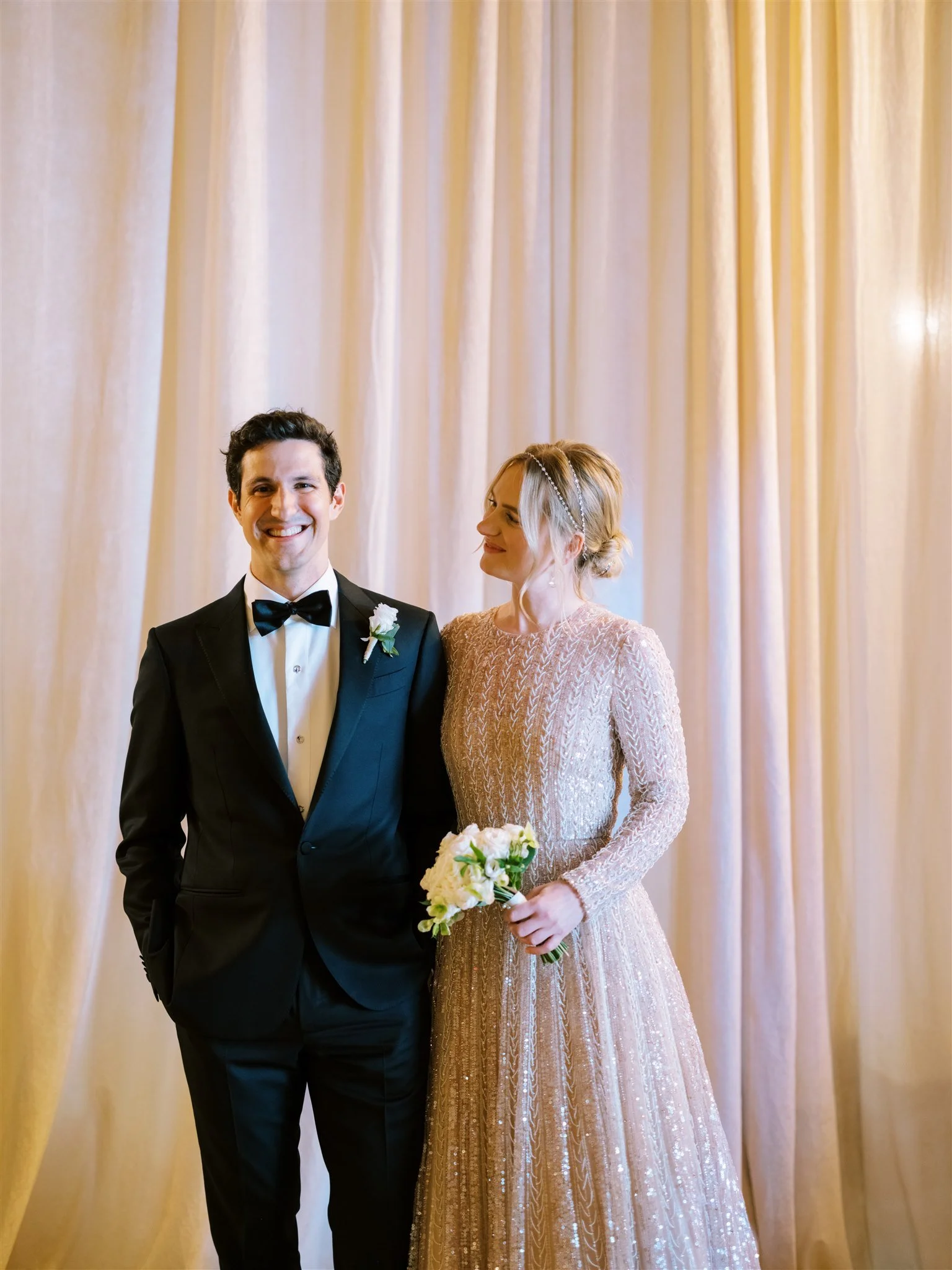 Classic portrait of the couple framed by gold drapery. michelle rago destinations wedding planner nyc.