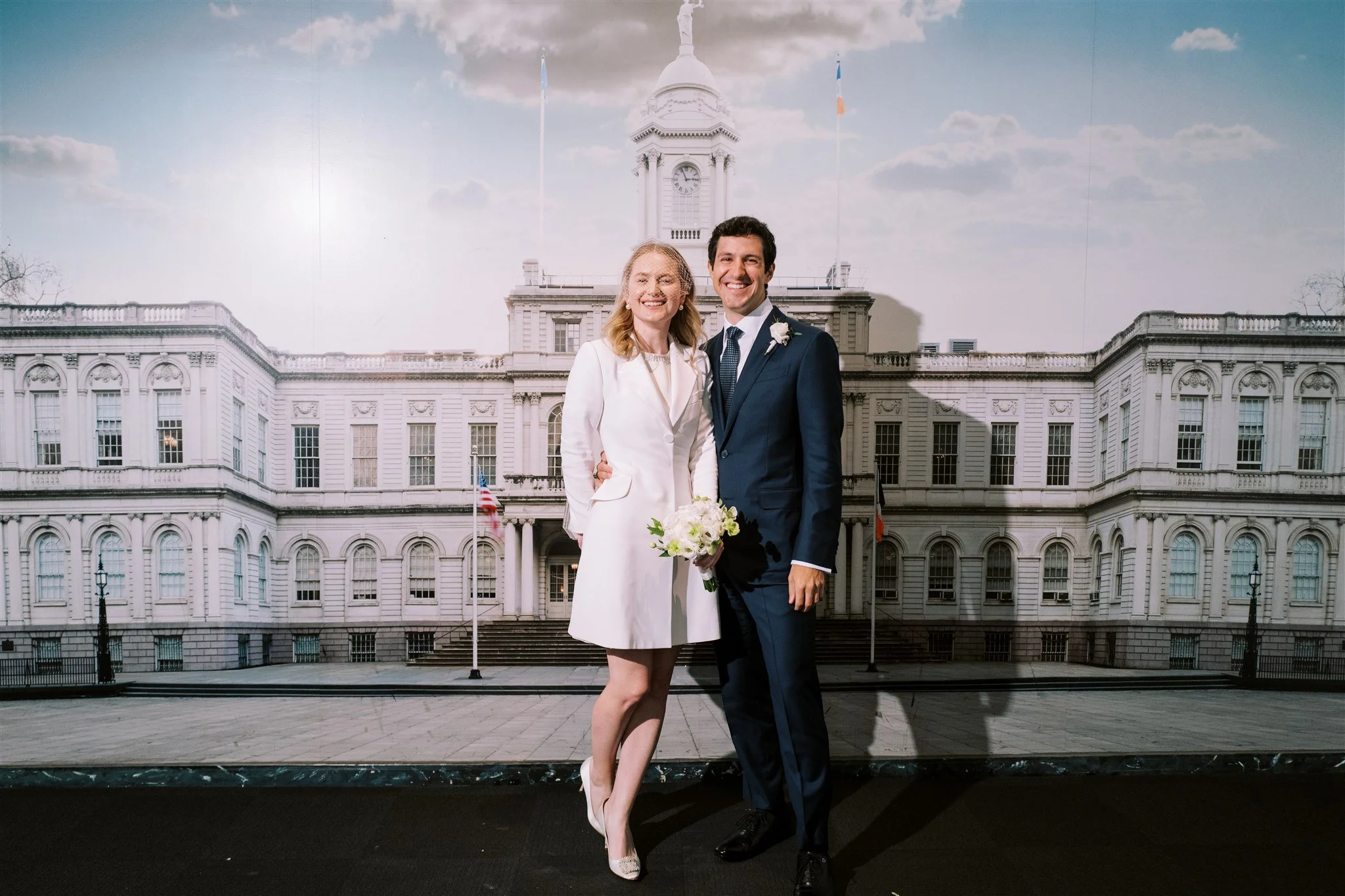 Formal portrait of the couple with City Hall architecture behind them. michelle rago destinations new york wedding planner.