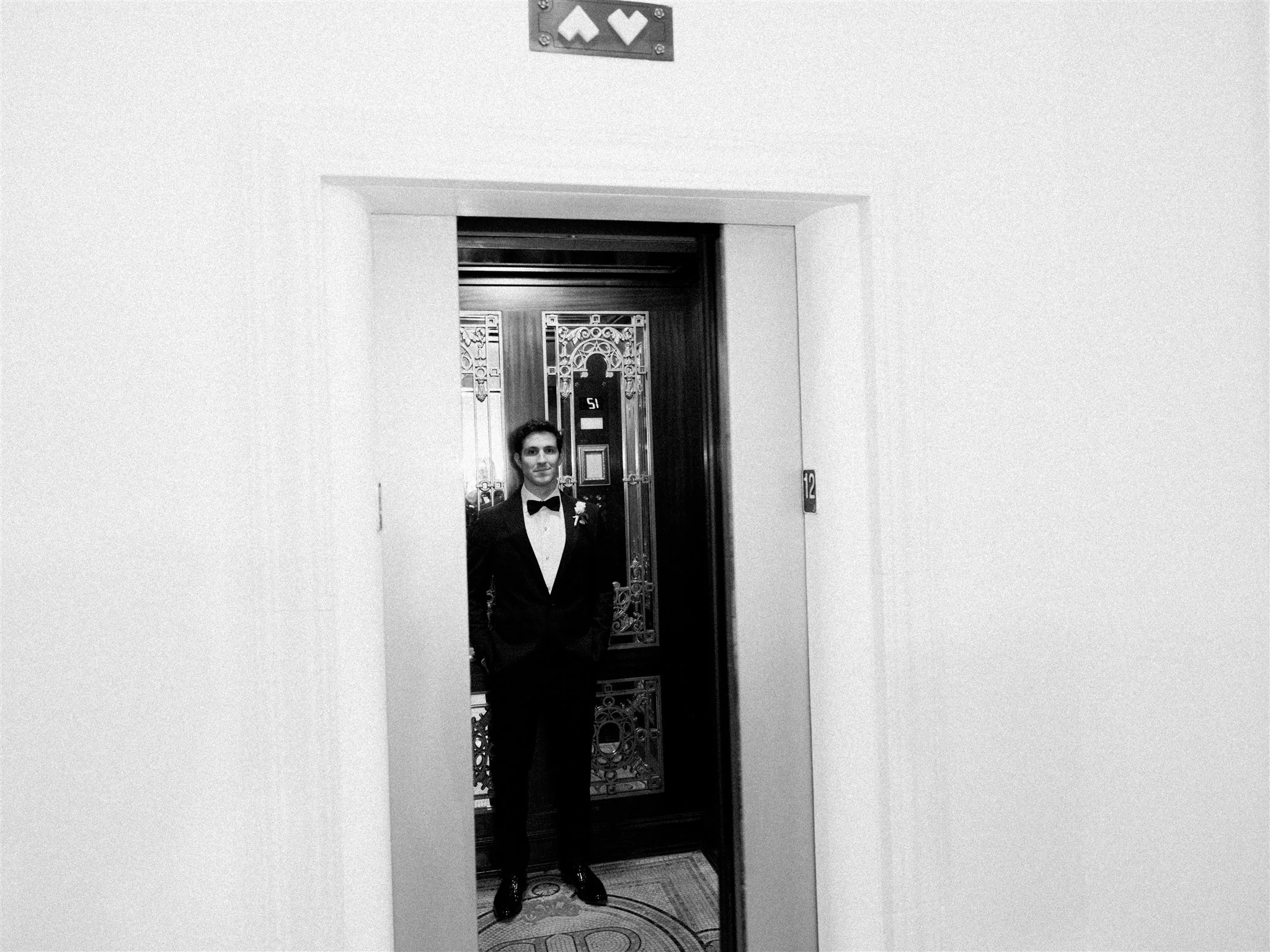Timeless portrait of the groom inside a vintage elevator. the plaza hotel nyc luxury wedding.