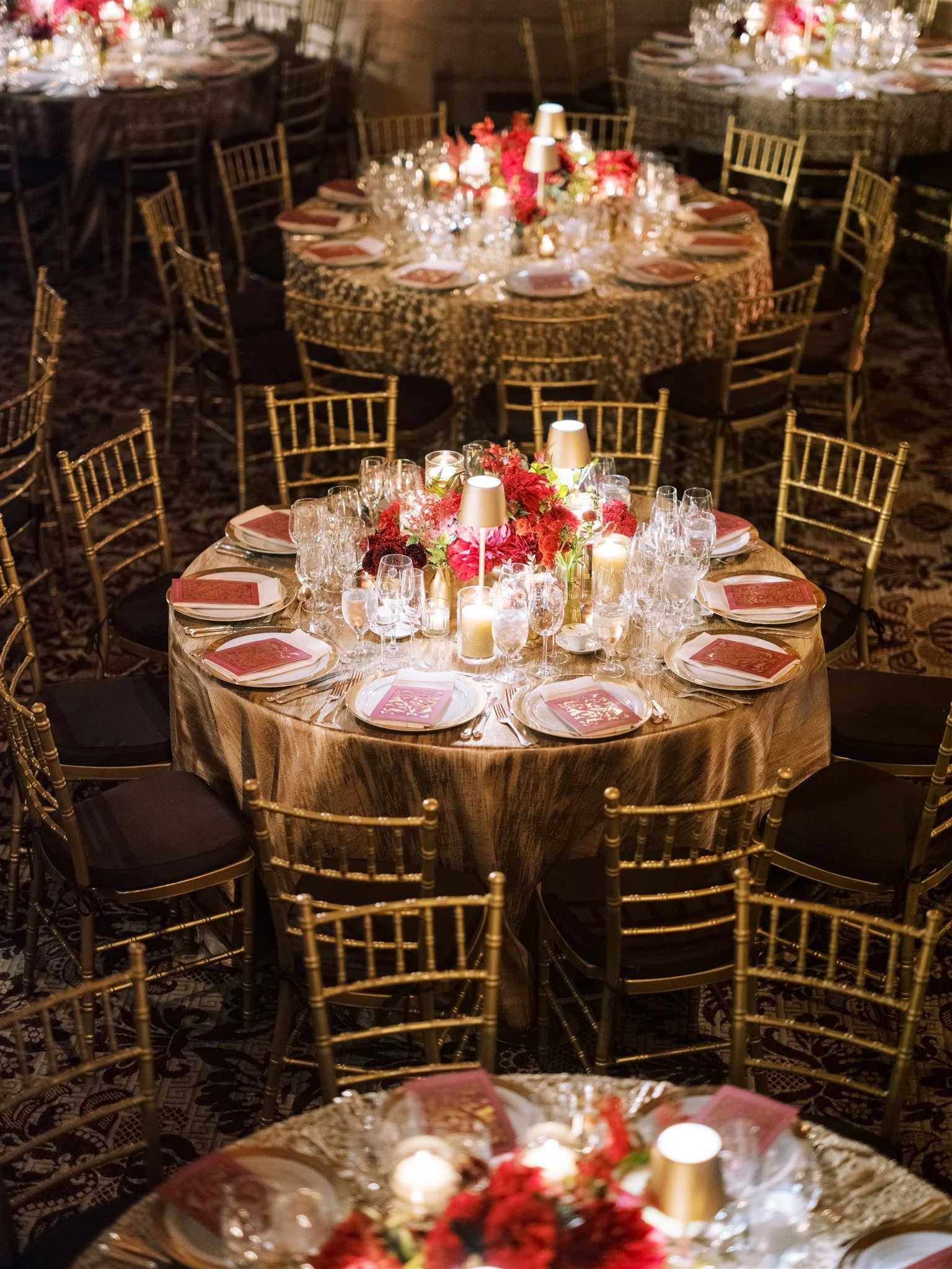 Elegant round tables with candlelight and gold décor and candlelight. plaza hotel wedding new york city.
