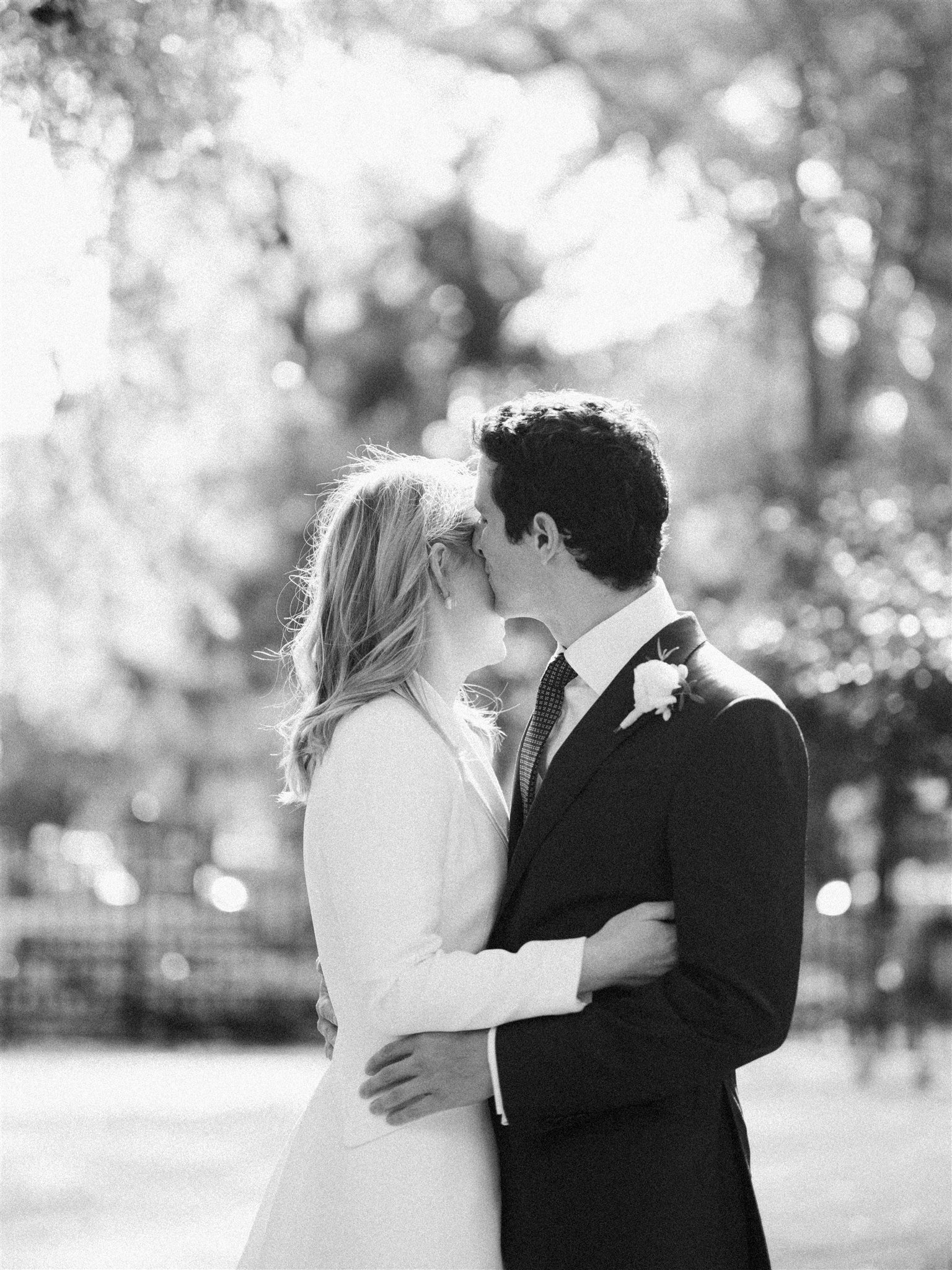 A soft, romantic kiss beneath the trees. michelle rago destinations nyc wedding planner.