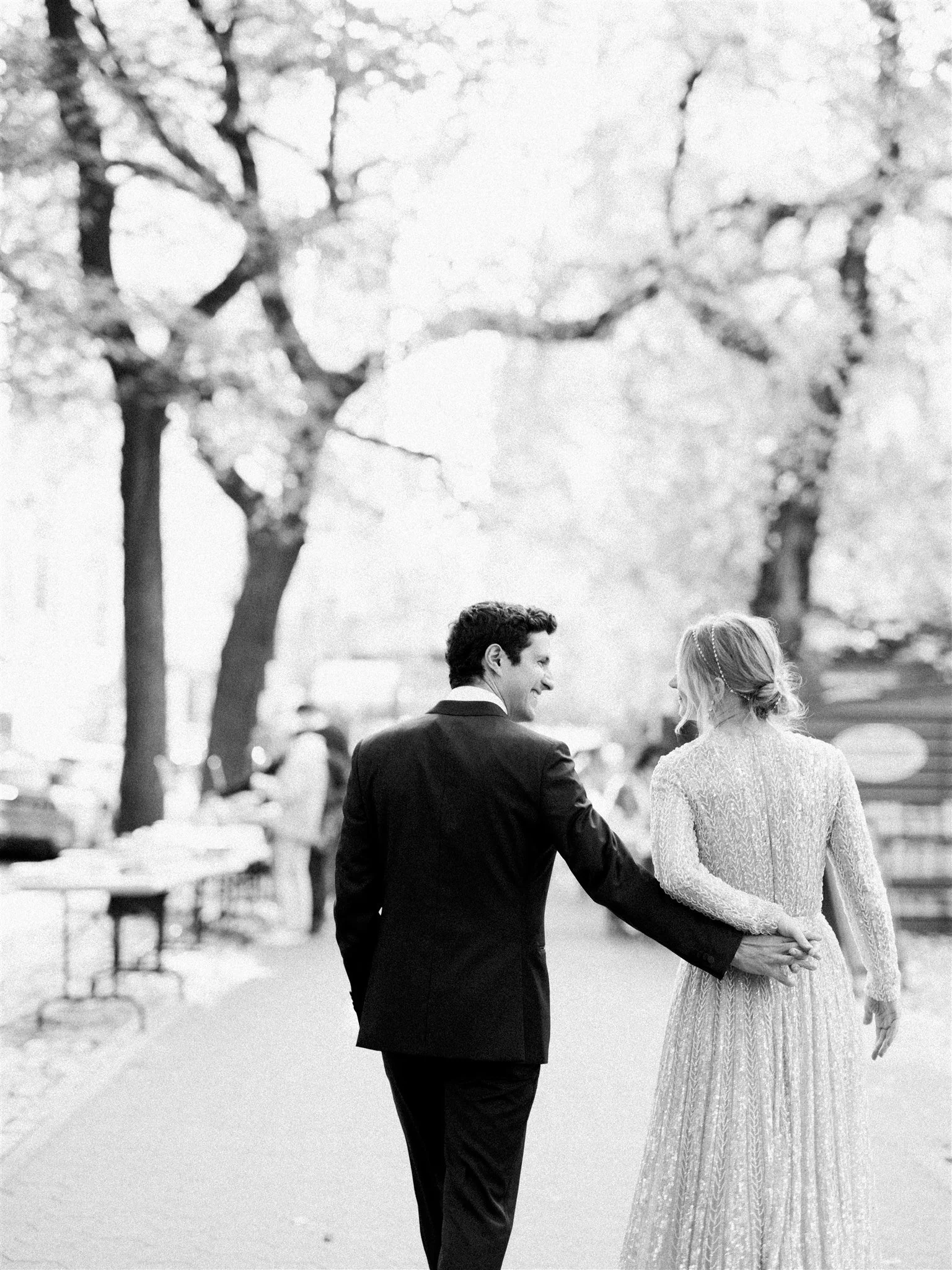 bride & groom walk hand and hand in central park, new york