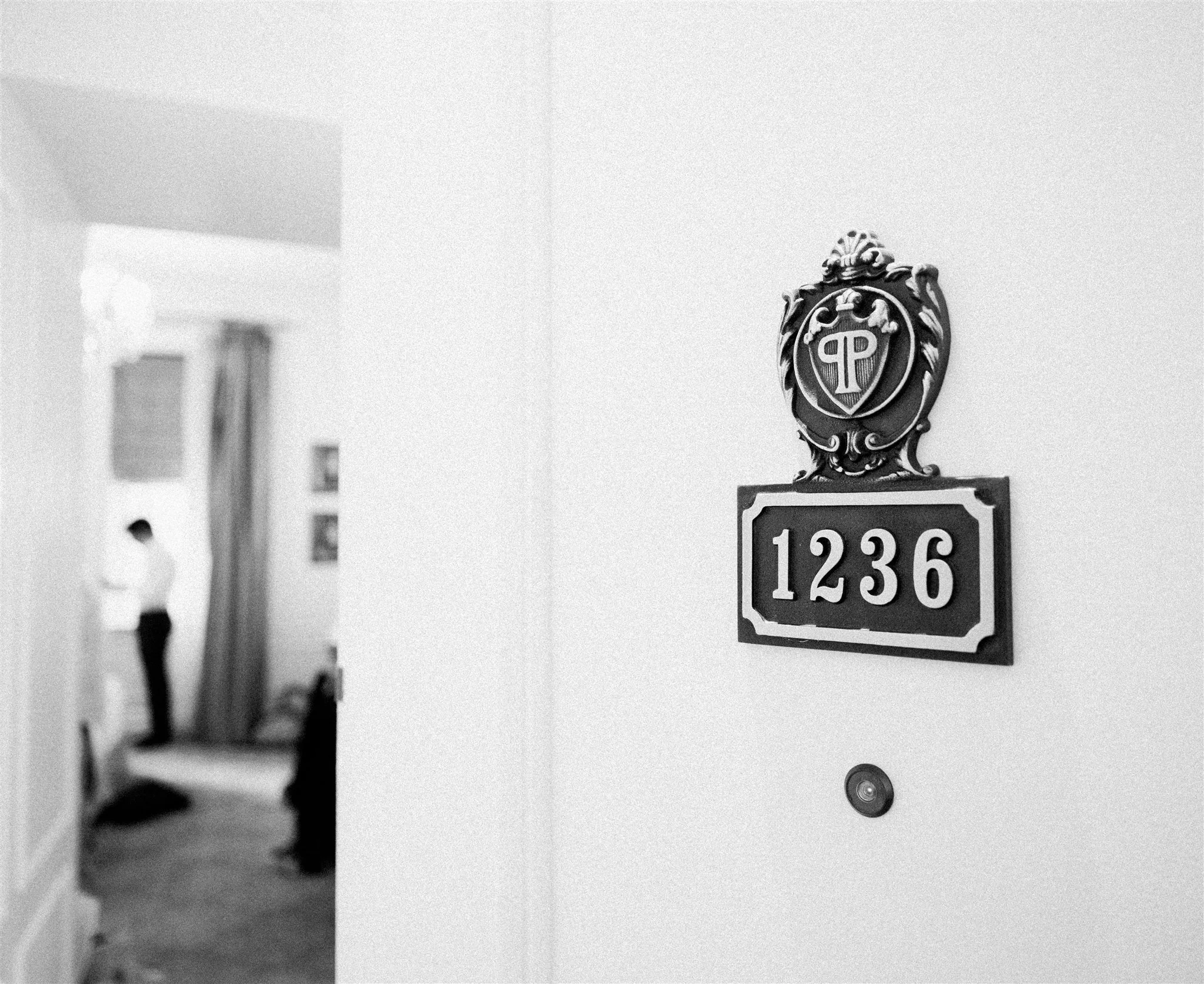 Close‑up of hotel room number plaque during morning prep. plaza hotel wedding new york city.