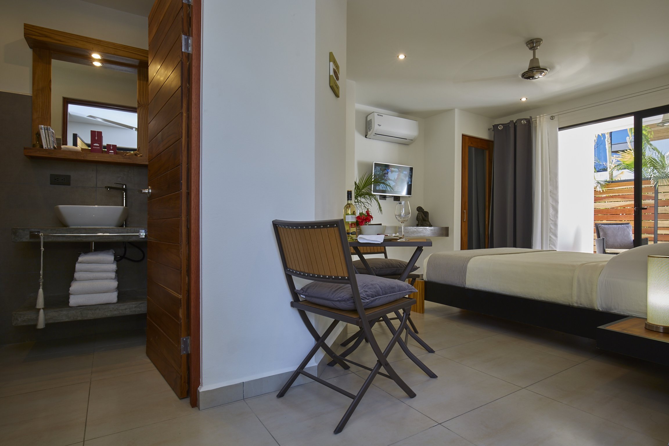 Downstairs Studio Apartment (East) from front door, bathroom, dining table, bed, sliding door to outdoor patio