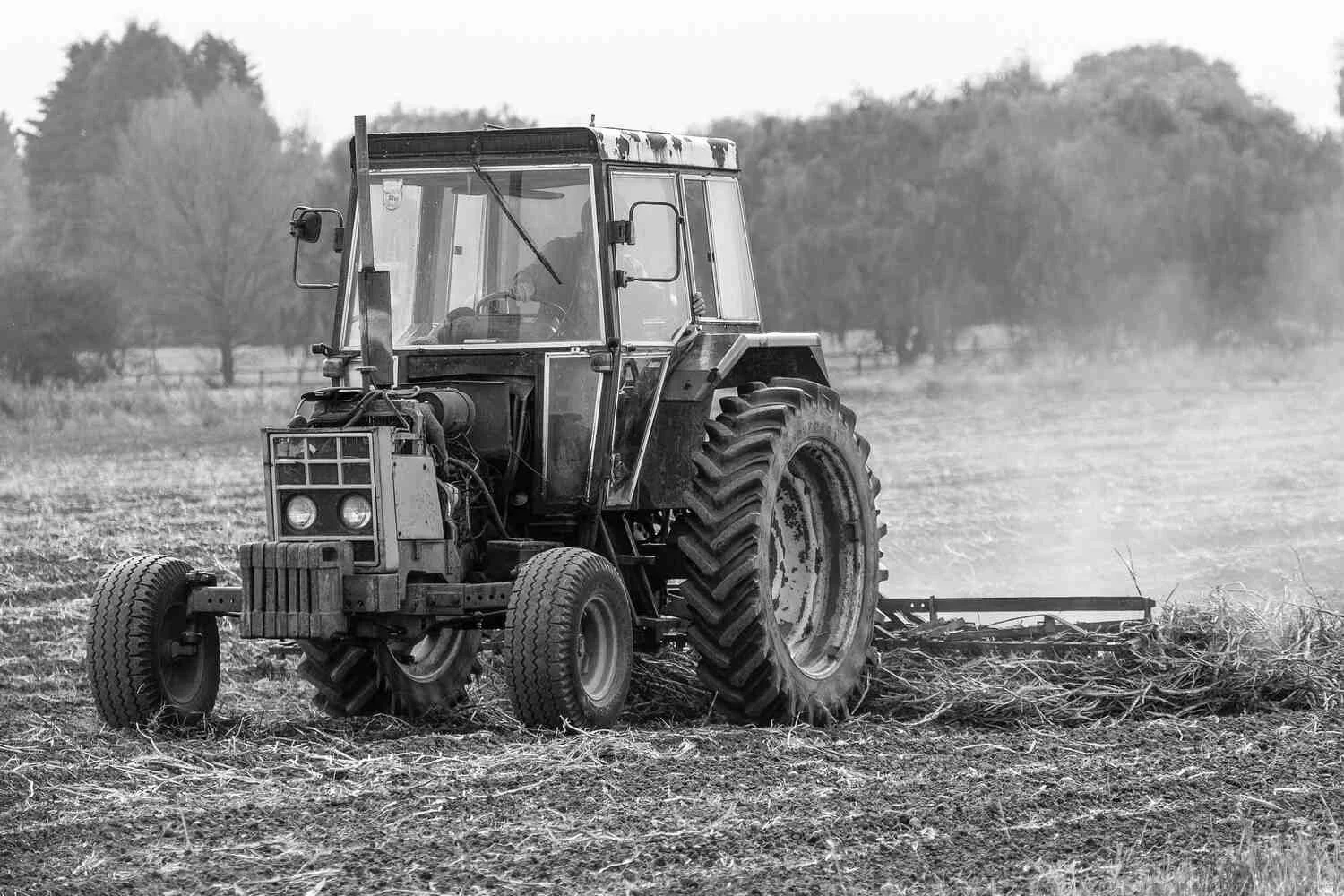 An old rusty case tractor in black and white photography-farming in the Cambridgeshire Fens.