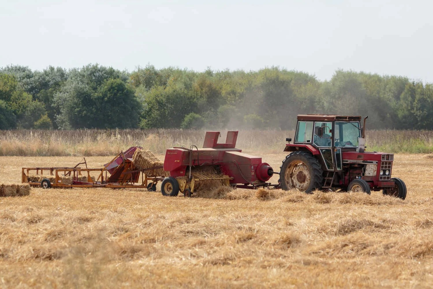 A classic case international 754 tractor with a vintage straw baler cambridgeshire Fens farming