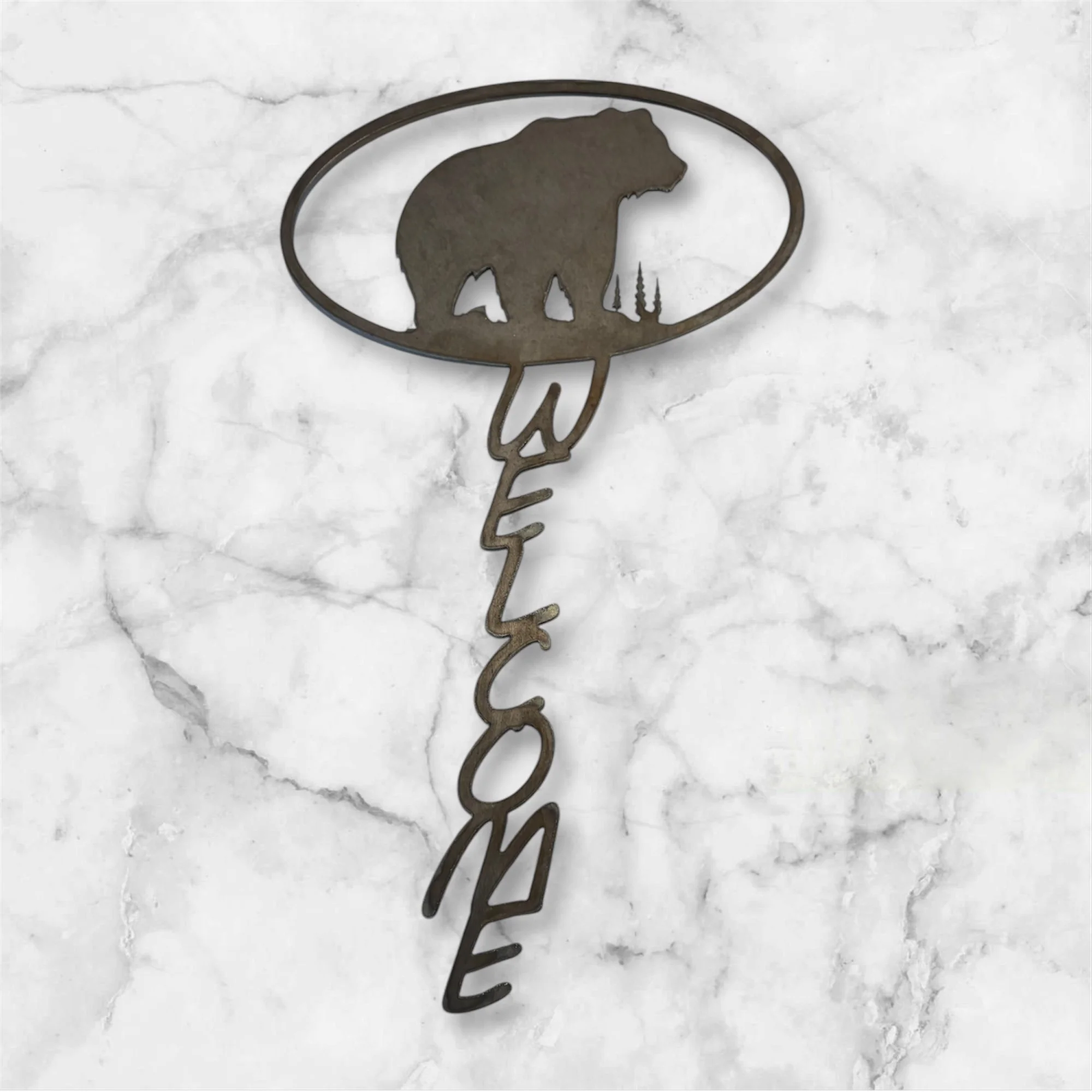 Metal wall decoration featuring a bear silhouette and the word 'WELCOME' written vertically.