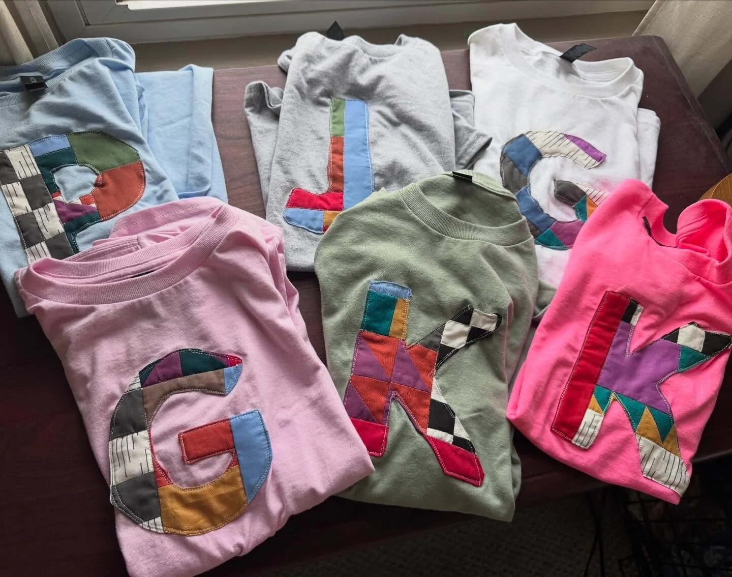 A sweet custom order shipping out today 💜💙❤️💛💚

Let me know if you want to create your own! 
Inspired by @newsongquiltingco &lsquo;s Modern Improv Quilting techniques.
#quilting #customtee #gift #improvquilting