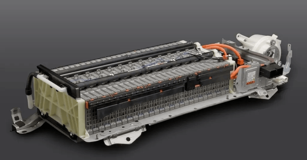 Electric vehicle battery pack with interconnected cells and wiring on a gray background.