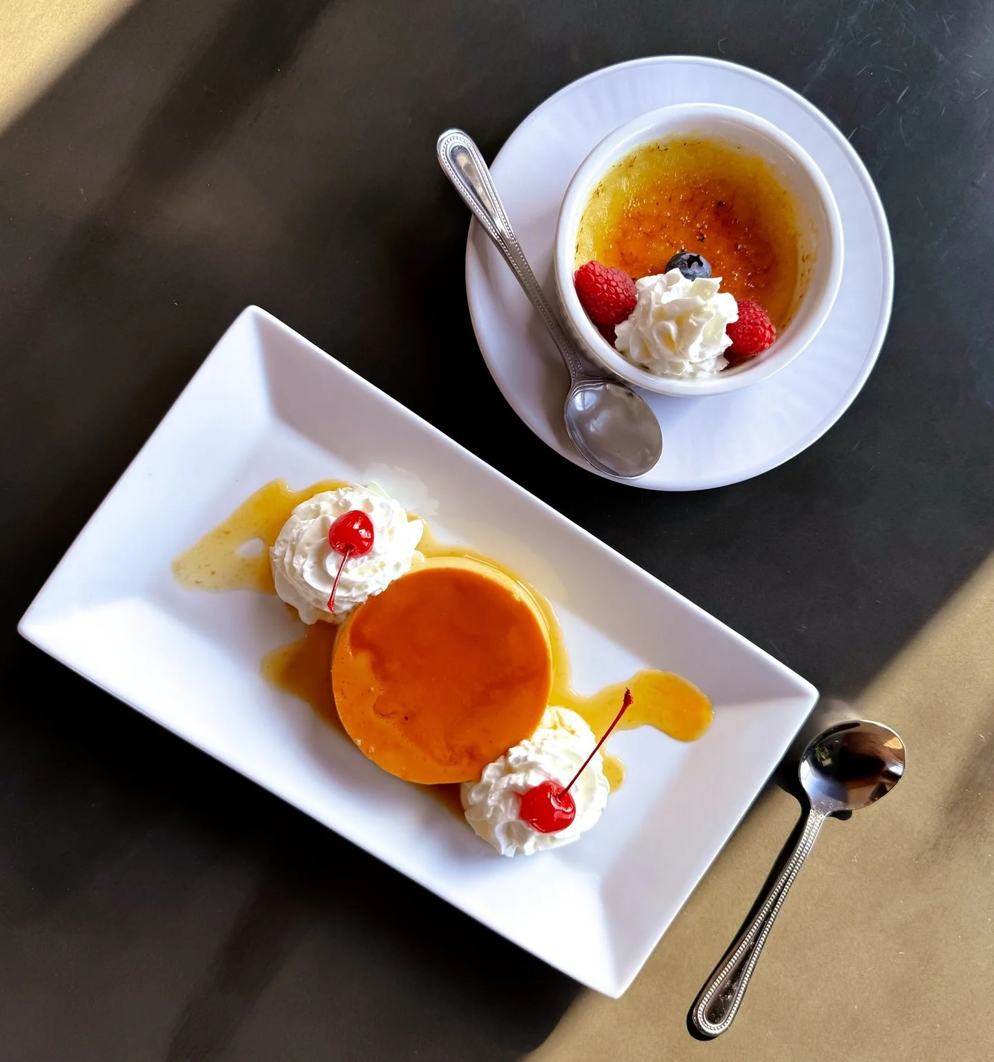 Flan and creme brule with whipped cream and fresh fruit