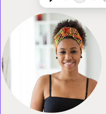 Young woman with curly hair wearing a colorful headband and black top, smiling indoors.