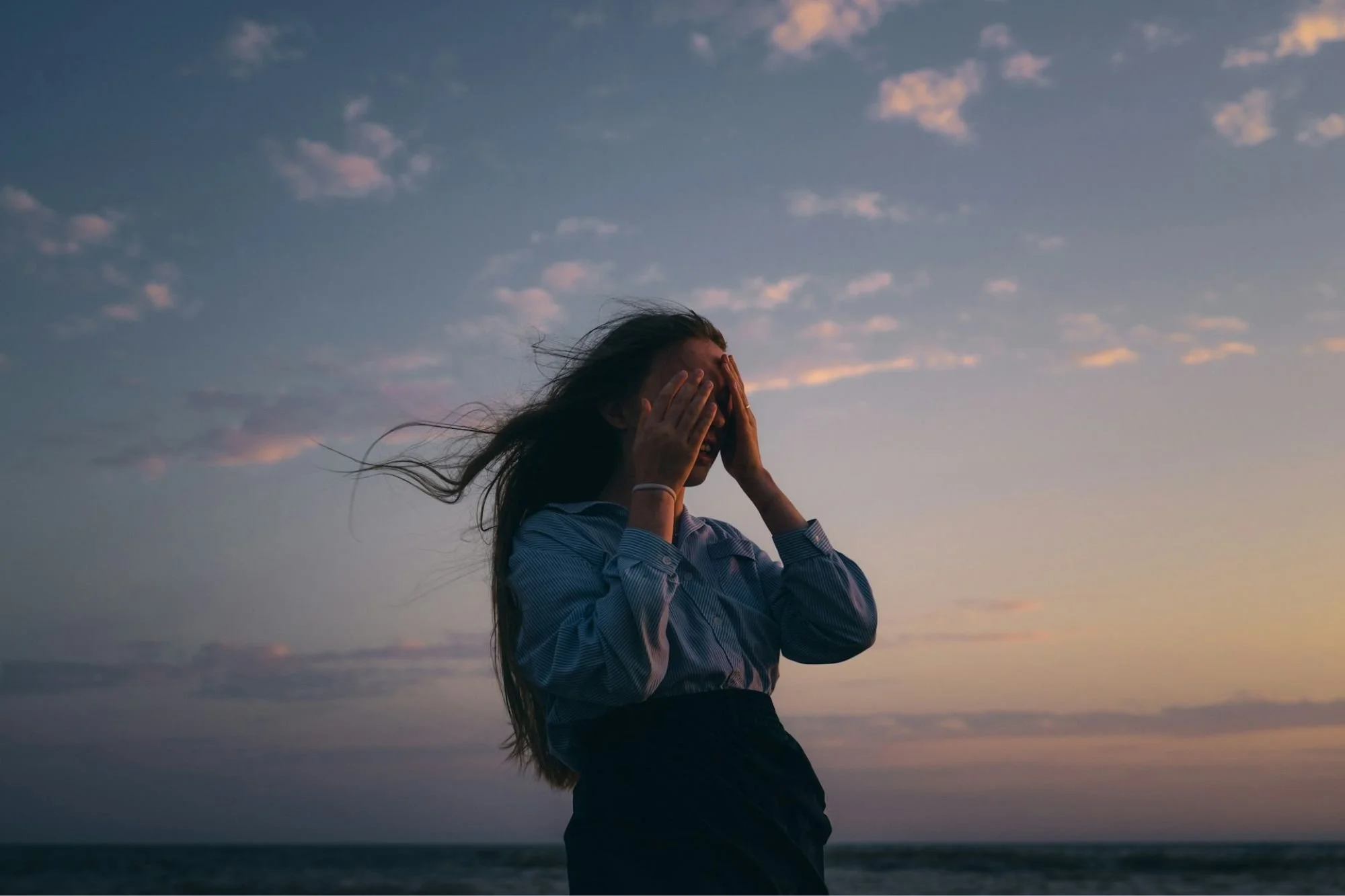 A quiet moment by the sea, reflecting the emotional weight of uncertainty on the fertility journey
