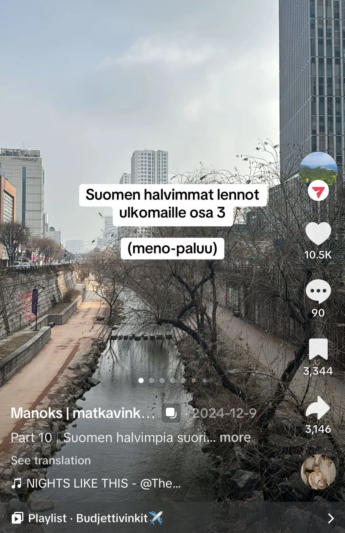 Kuvassa kaupunkinäkymä joen ja puiden keskellä, taustalla korkeita rakennuksia ja pilvenpiirtäjiä, sininen taivas ja osittain pilviä.