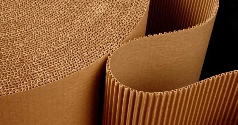 Close-up of various brown corrugated cardboard sheets with different textures and shapes.