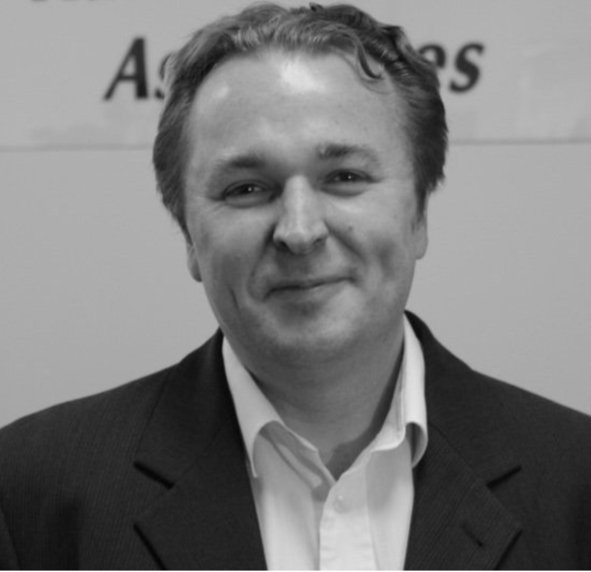 Black and white image of Glenn Petersen smiling 