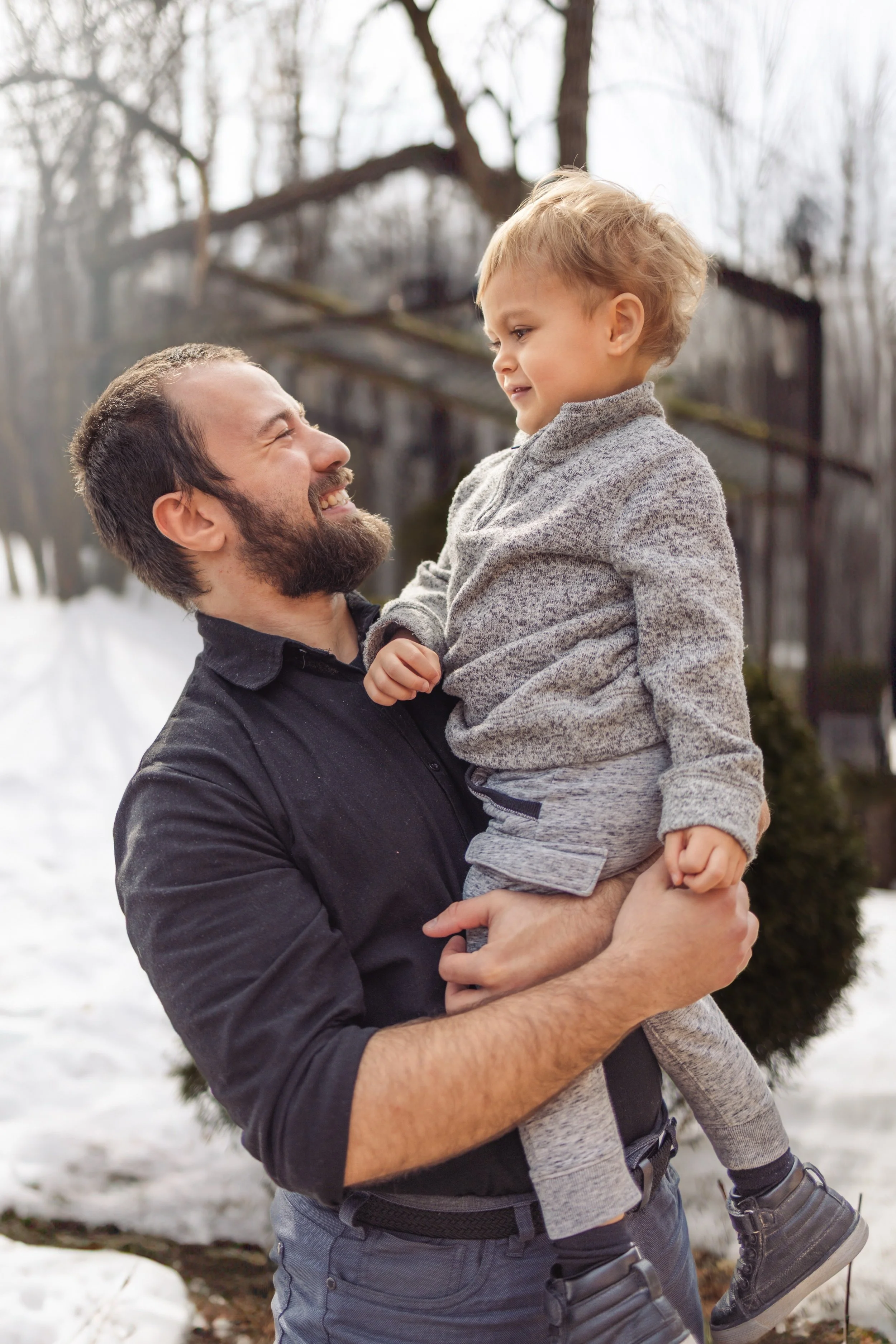 Calgary family photography, man smiling outdoors with toddler.