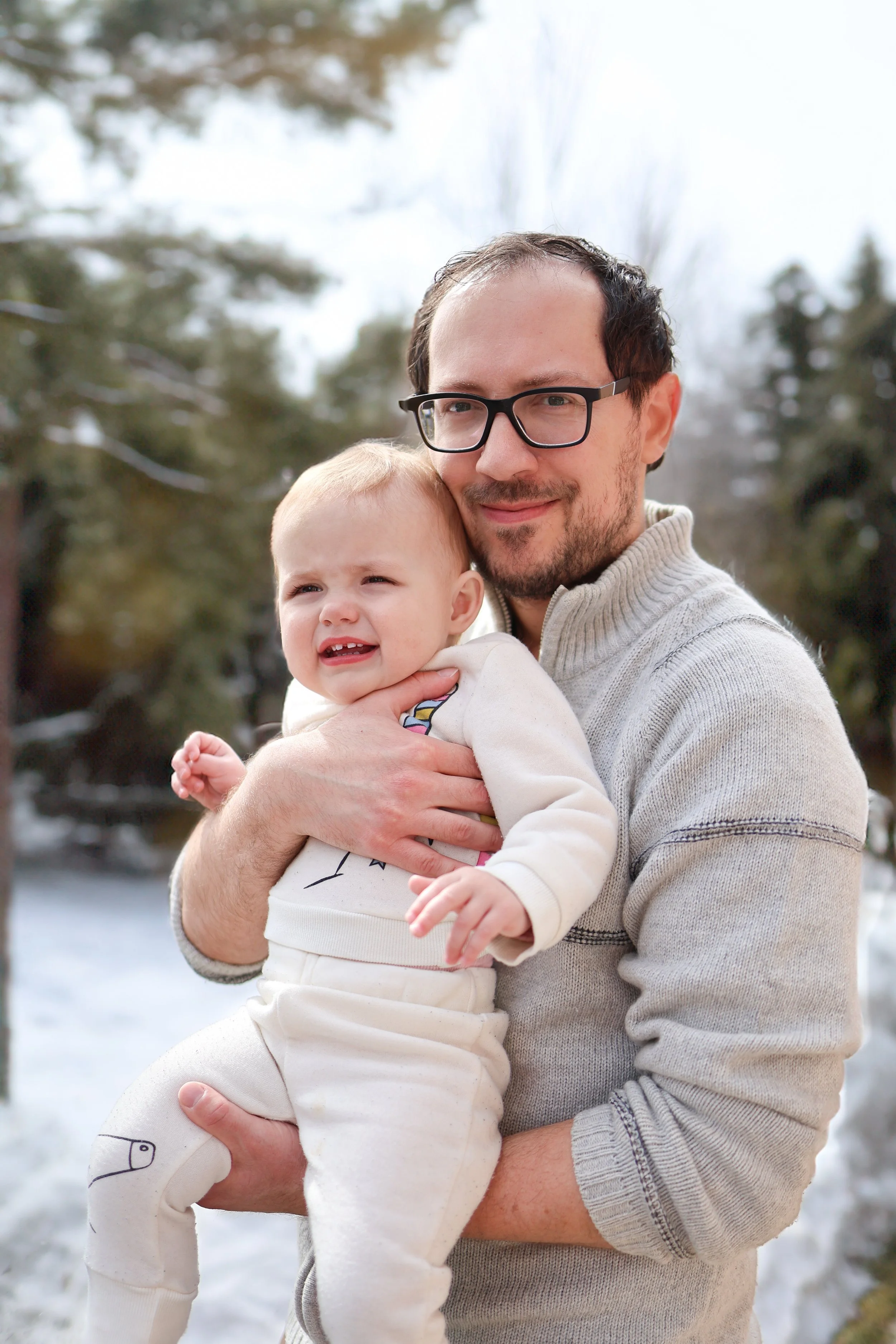 Calgary family photography, man smiling outdoors with toddler.