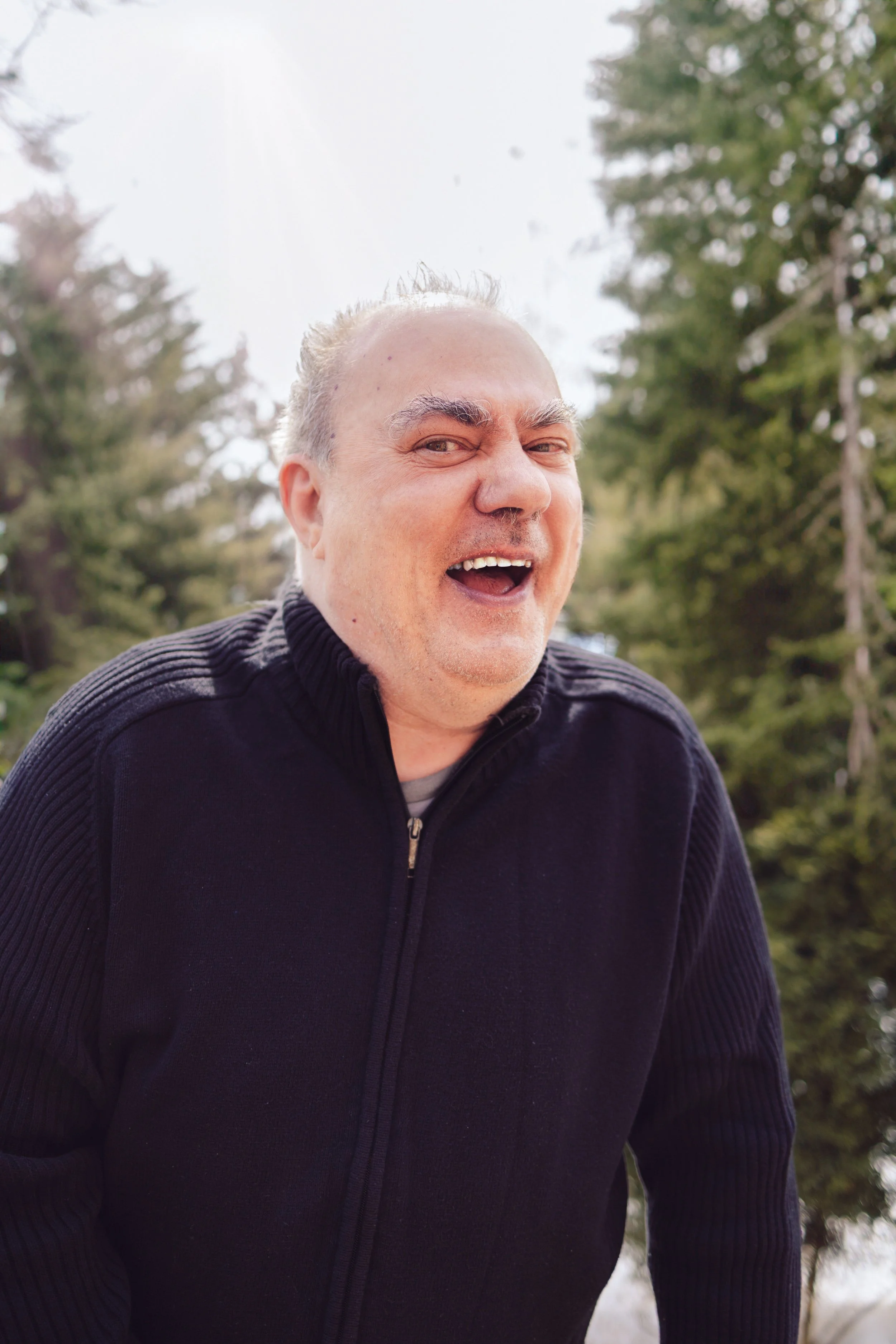 Calgary family photography, grandfather smiling outdoors.