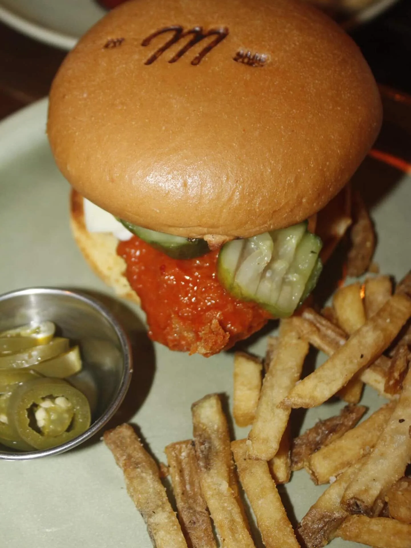 The Buffalo Burger 🦬 crispy organic chicken, blue cheese buffalo sauce, house made pickles and sauerkraut on a brioche bun. As always, with our own double cooked fries 🥔
