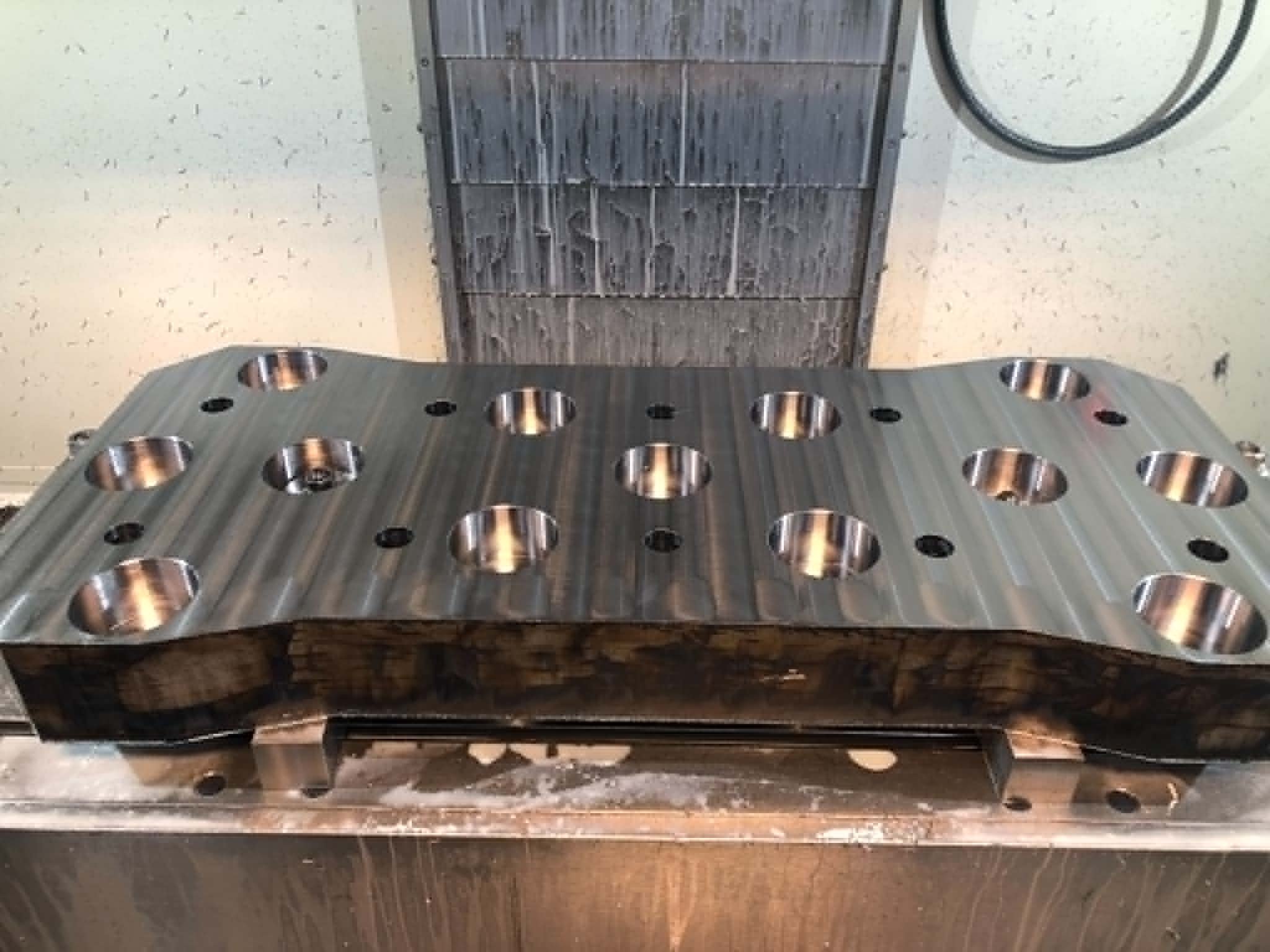 Heavy Industry adapter plate and CNC equipment in the background.