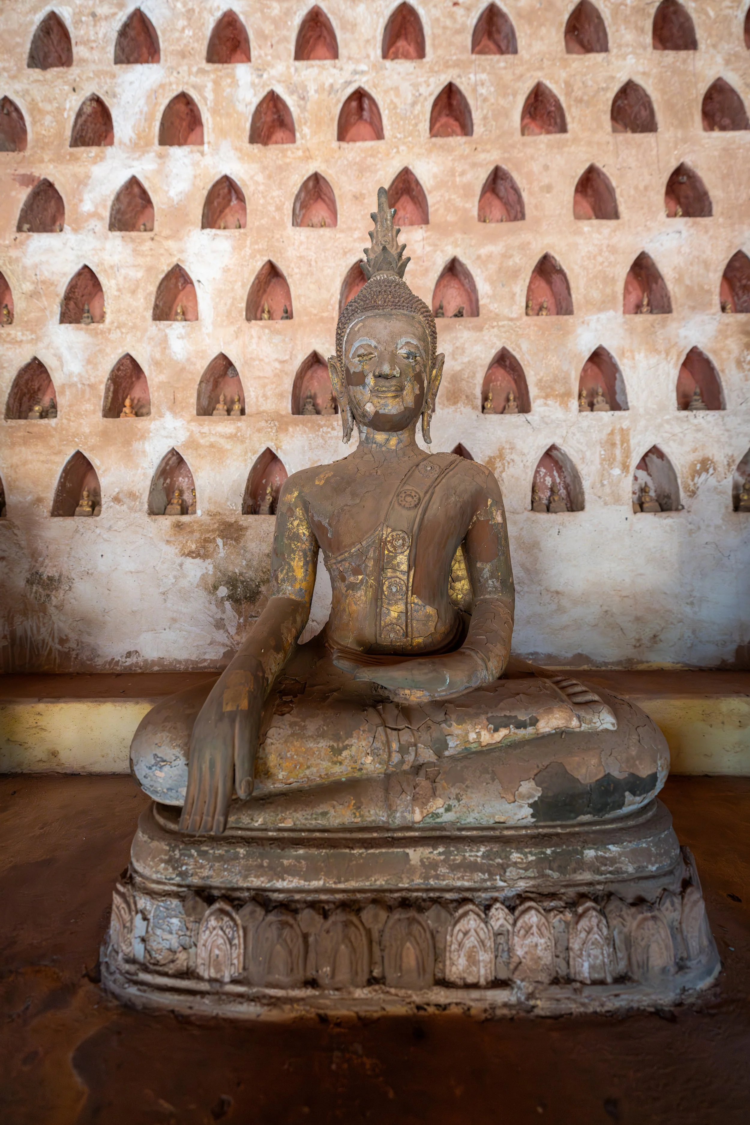 Die Vielzahl von Buddhafiguren symbolisiert im Buddhismus die kontinuierliche Weitergabe von Lehre und Mitgefühl über Generationen hinweg.