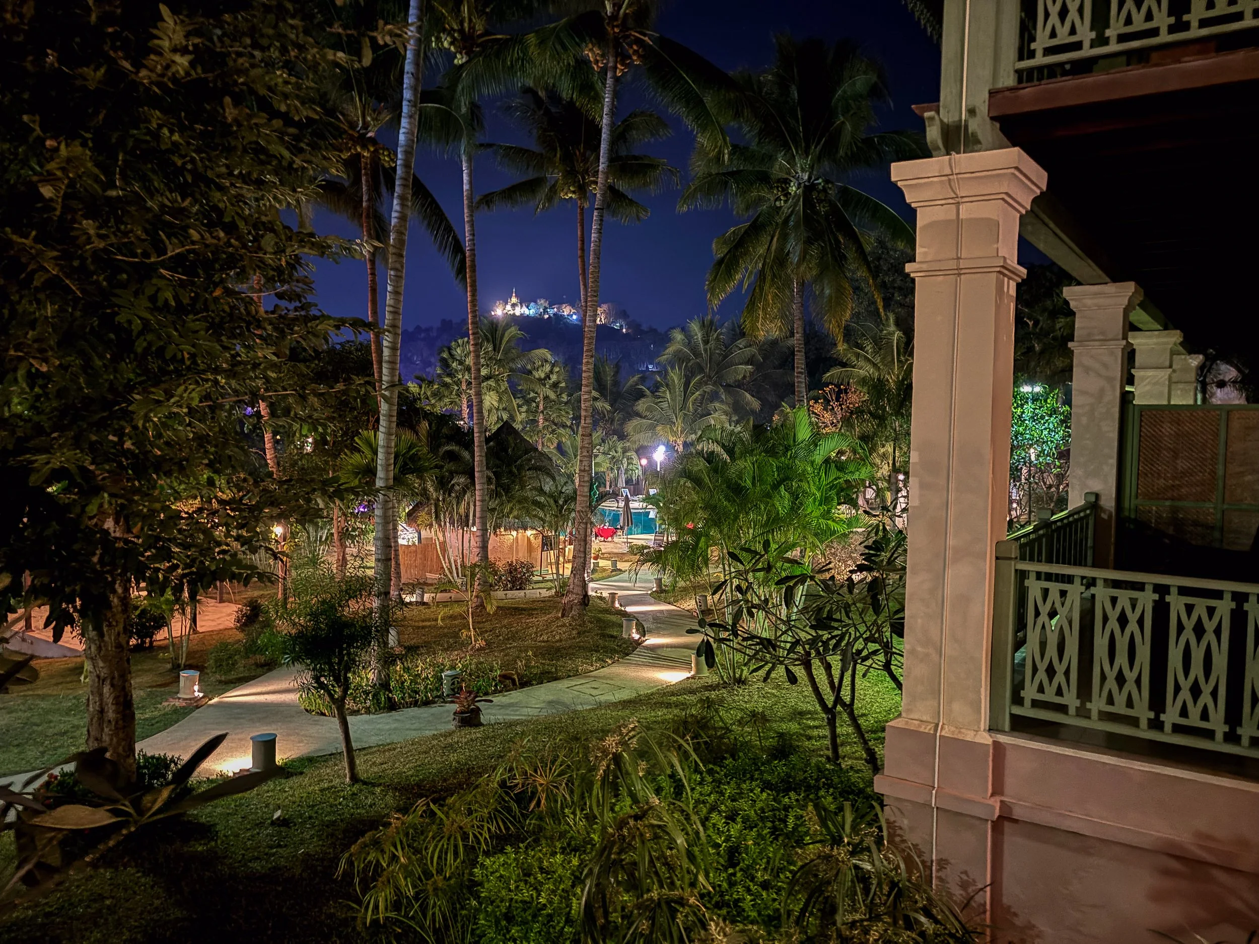Nach Einbruch der Dunkelheit hebt sich der beleuchtete Phousi Hill als markanter Mittelpunkt über der ruhigen Stadtlandschaft ab.