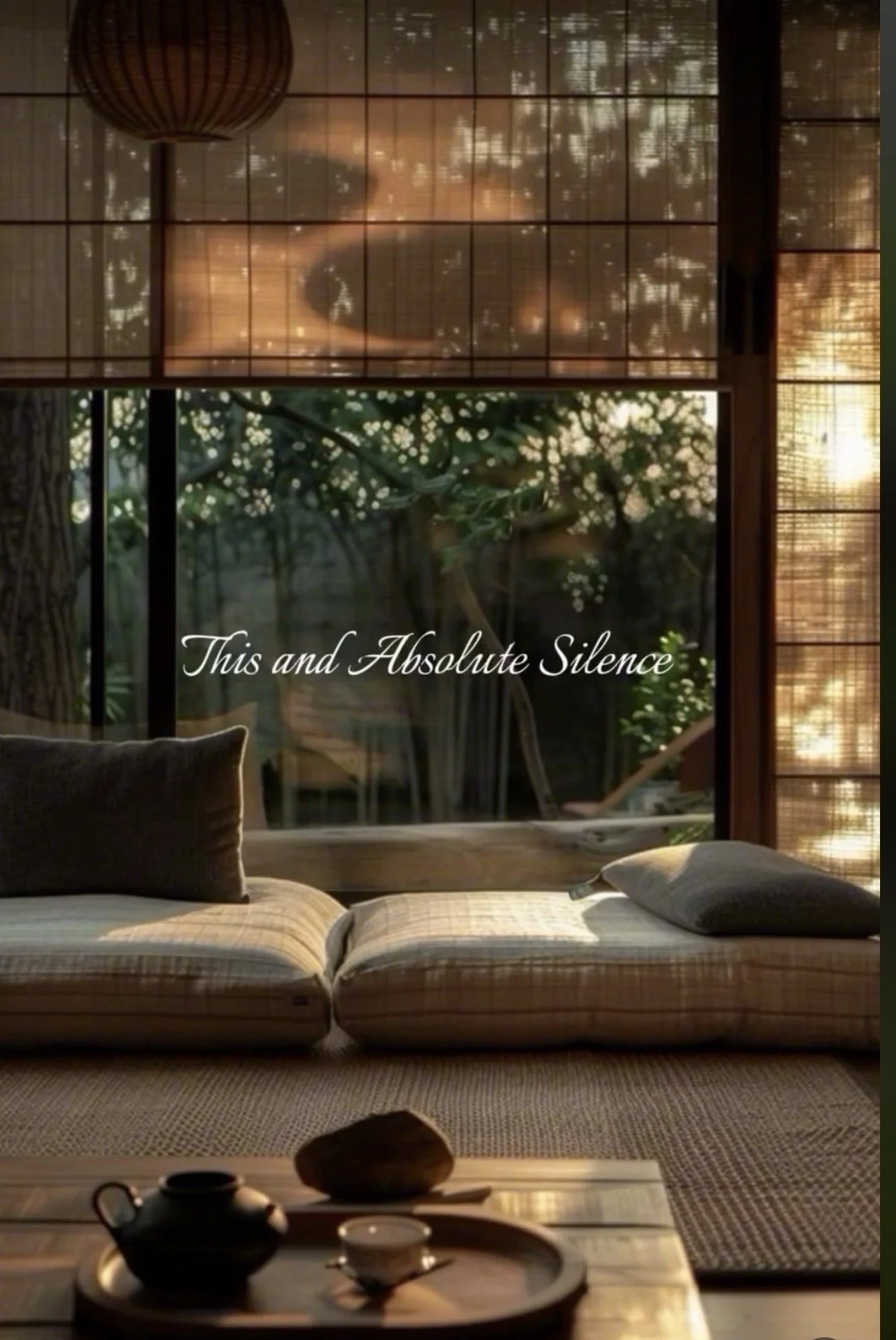 A cozy interior scene with a low table holding tea set, cushions on a padded floor, large windows revealing trees outside, and soft lighting creating a warm ambiance. The text 'This and Absolute Silence' is overlaid on the scene.