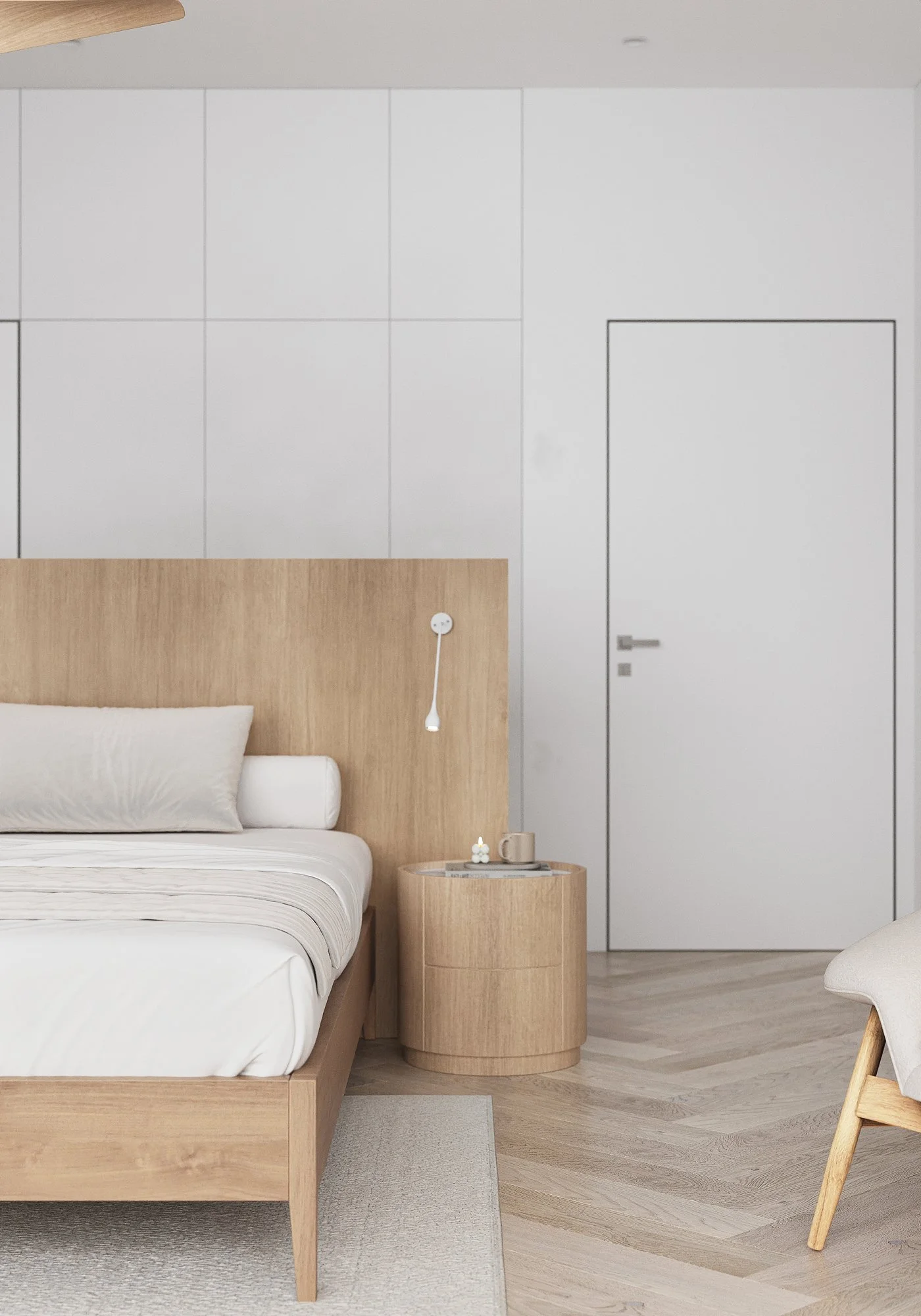 Minimalist bedroom with wooden bed frame, white bedding, round nightstand with a mug and small item, folding chair, and white wall with a door.