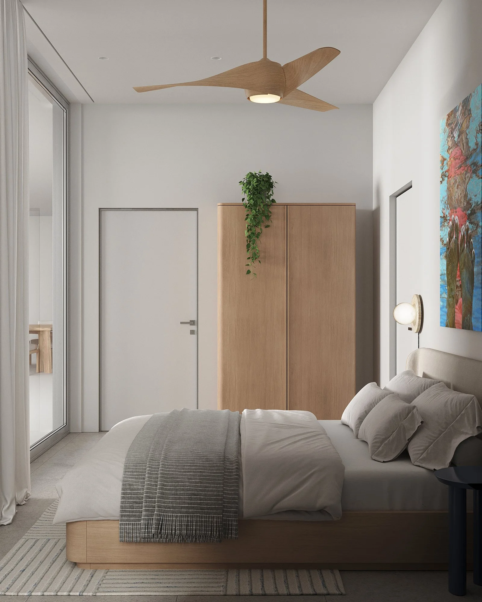 A modern bedroom with a bed, gray and white bedding, a wooden wardrobe with a hanging green plant on top, a ceiling fan, a wall-mounted lamp, an abstract painting, and a sliding glass door.