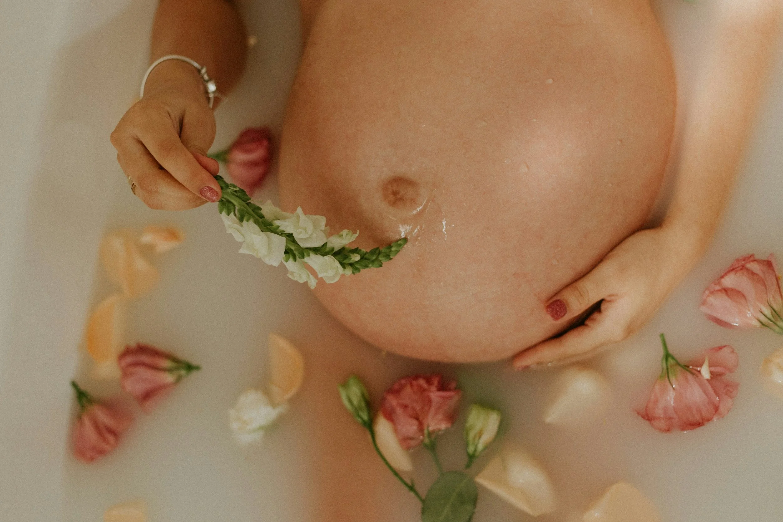 Pregnant belly decorated with flowers, prenatal care by Birthing by Nature in Simi Valley, CA