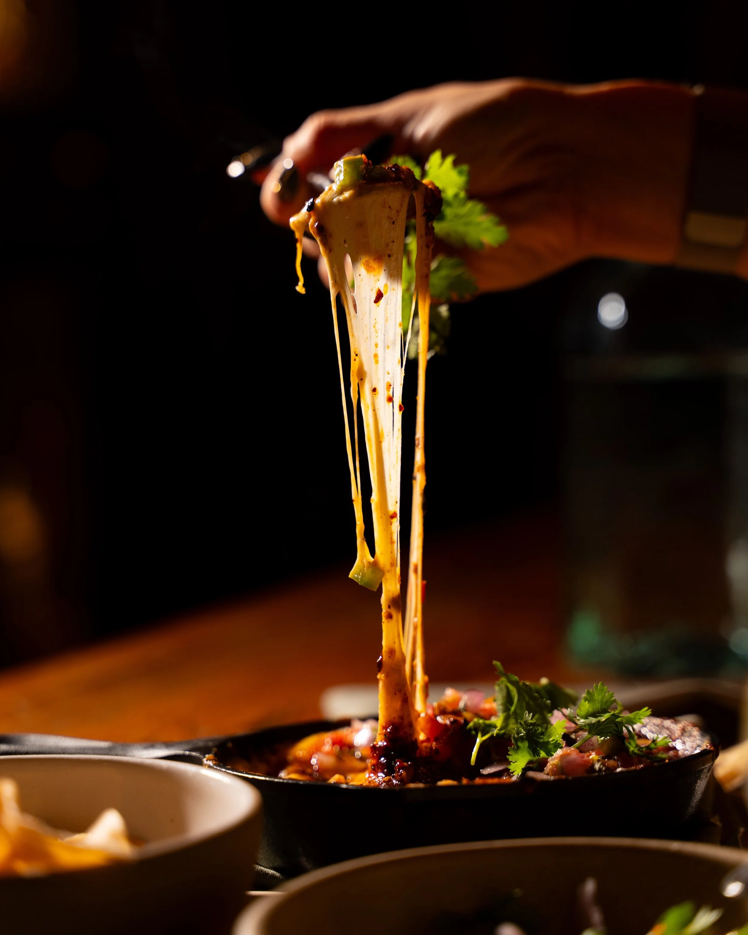 That cheese pull?  That&rsquo;s the whole point.

Our Queso Fundido is hot, bubbly, ridiculously melty, and absolutely not interested in being shared equally. Grab a tortilla, go for the pull, and claim your corner of the skillet before someone else 