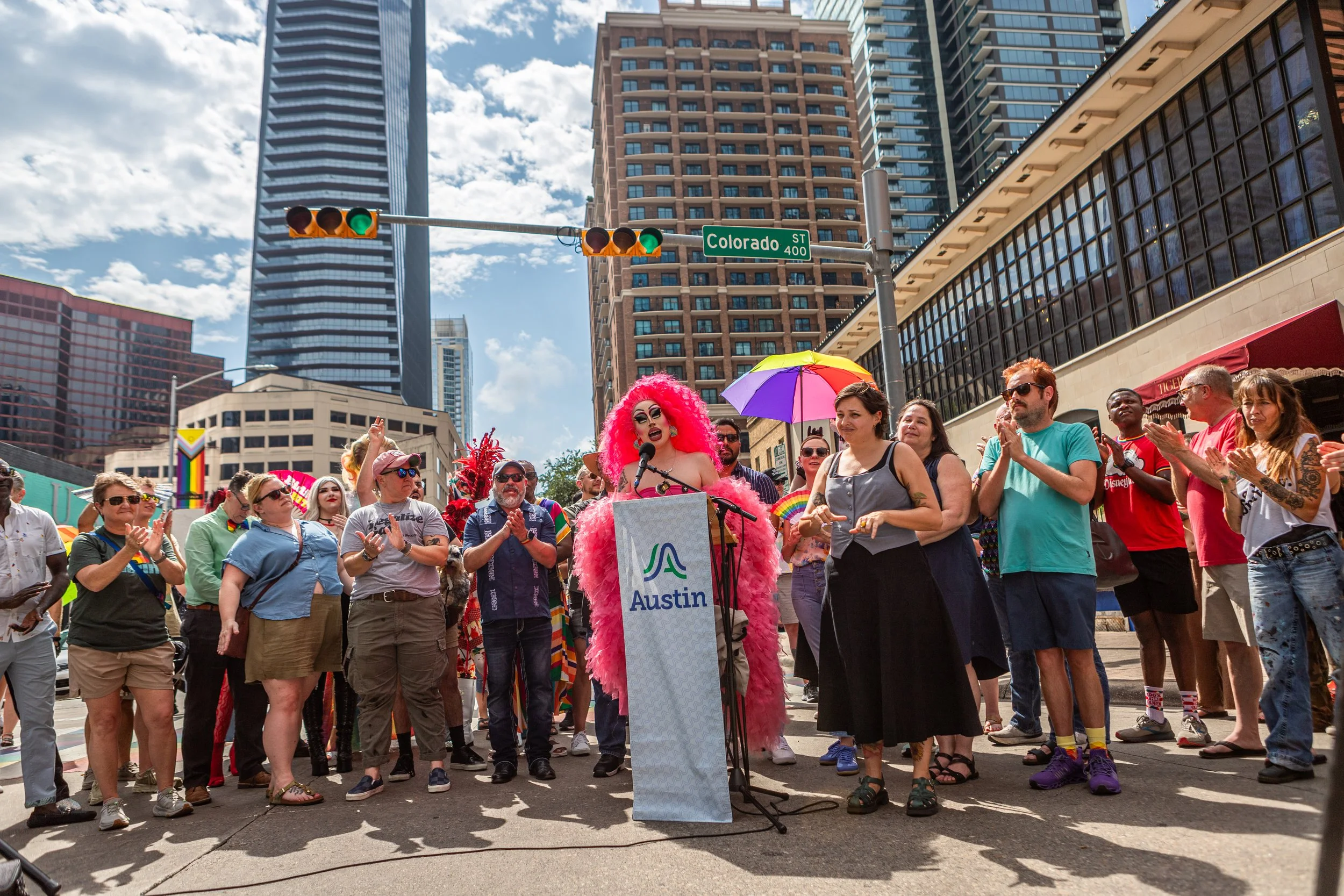 Drag queen Brigitte Bandit explains why it is important to take action and protect the LGBT community during the installed mural event on 4th Street on June 20, 2026, in downtown Austin, TX. 