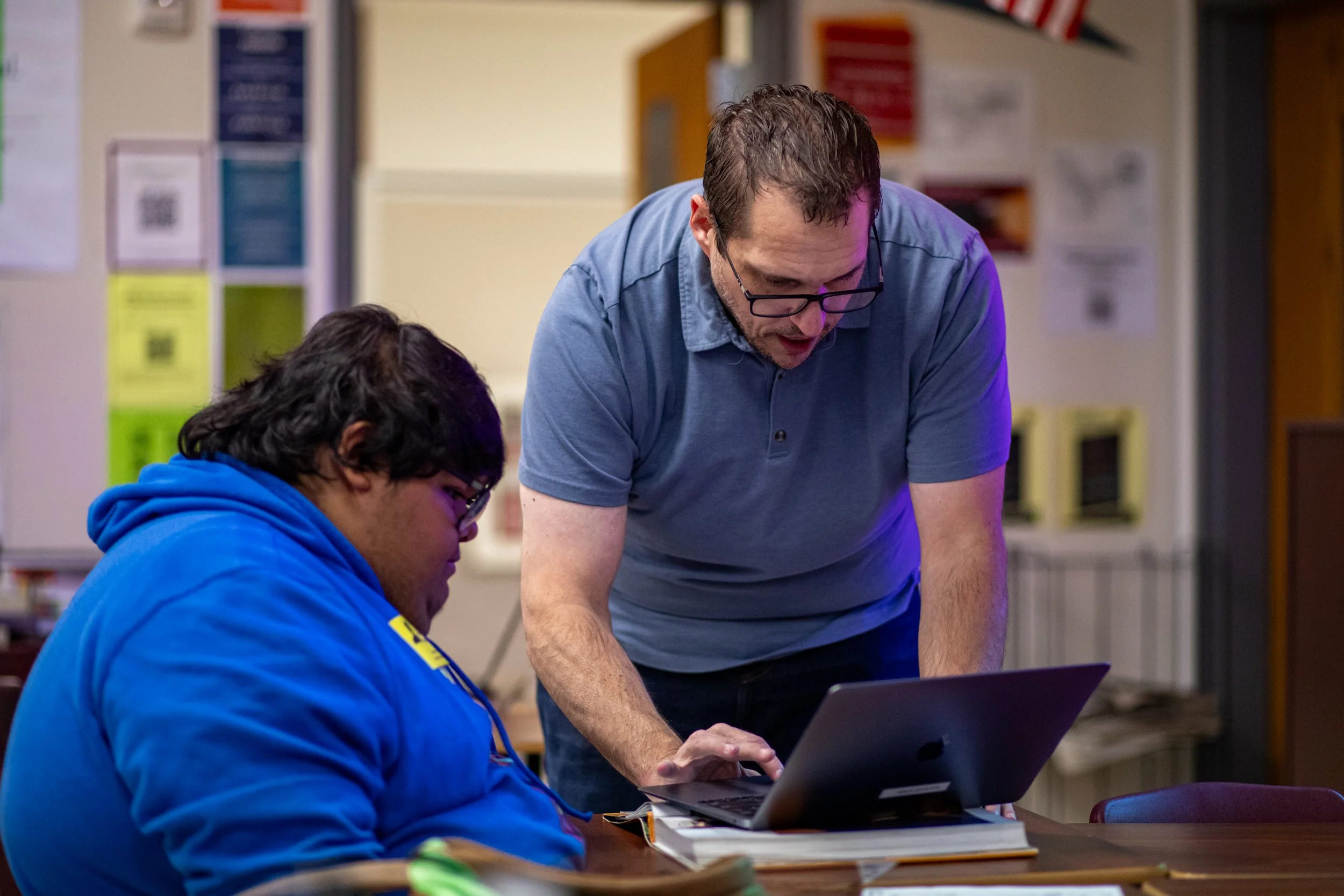 Hale helps a student who struggles with creativity when designing yearbook spreads during his Journalism I class. As long as students put in the effort, Hale does not mind helping out where he can. The only thing Hale cares about is if students are p