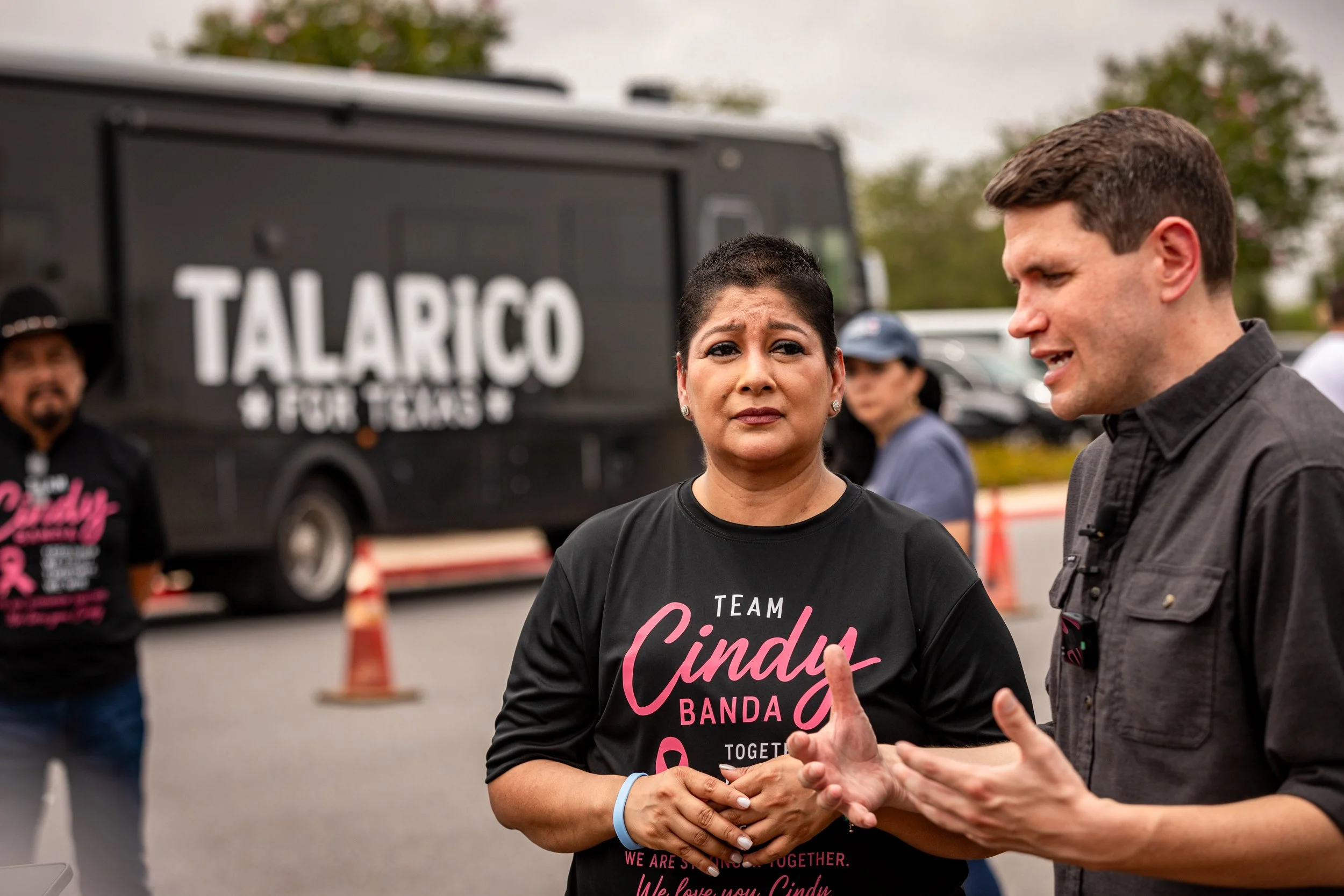 Cindy Banda listens to state Rep. James Talarico speak about healthcare affordability during his “Frontera Tour” in Edinburg, TX, on July 15, 2026. Banda is battling breast cancer and has helped pay for her treatment by selling plates in her communit