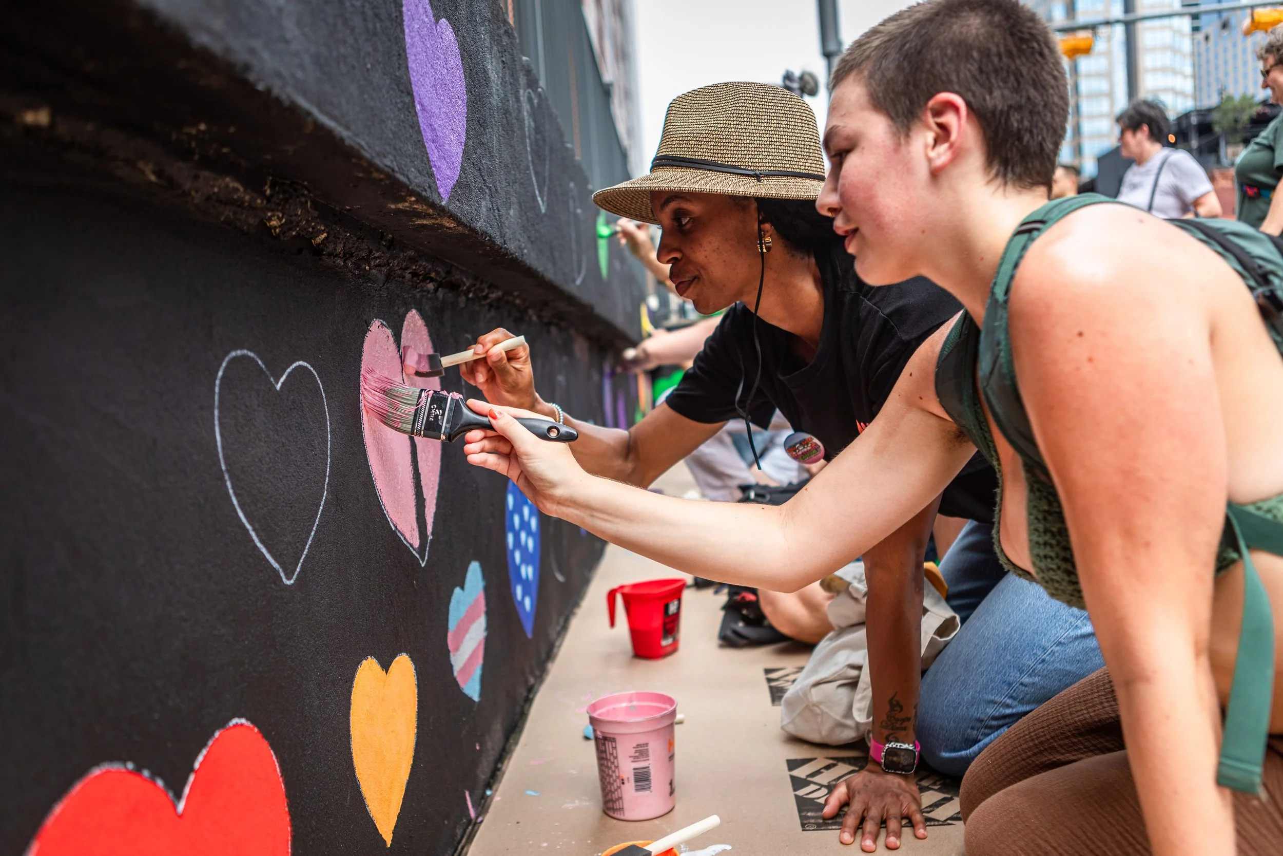 Attendees paint a new mural on 4th Street on June 20, 2026, to commemorate the spot where the rainbow crosswalk will soon be removed in Austin, TX. 