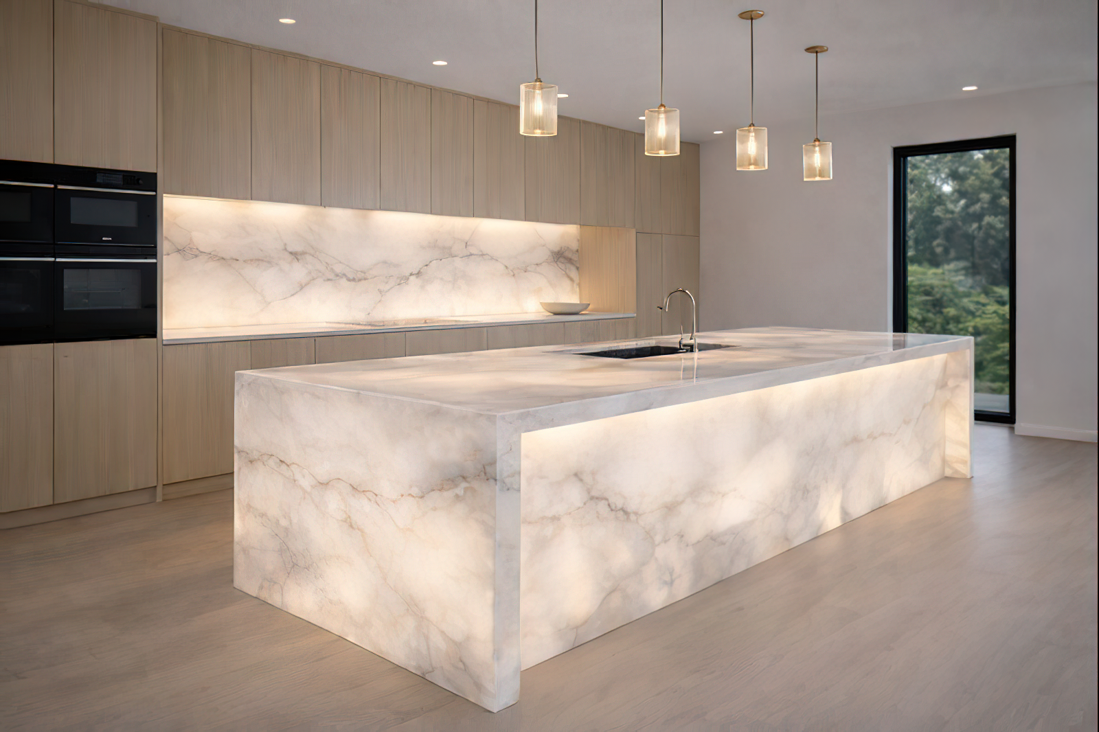 Modern kitchen with marble island and backsplash, wooden cabinets, black appliances, and large window showing trees outside.