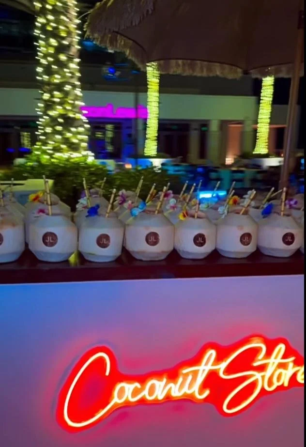 Multiple custom-branded coconuts on a live coconut bar at the event.