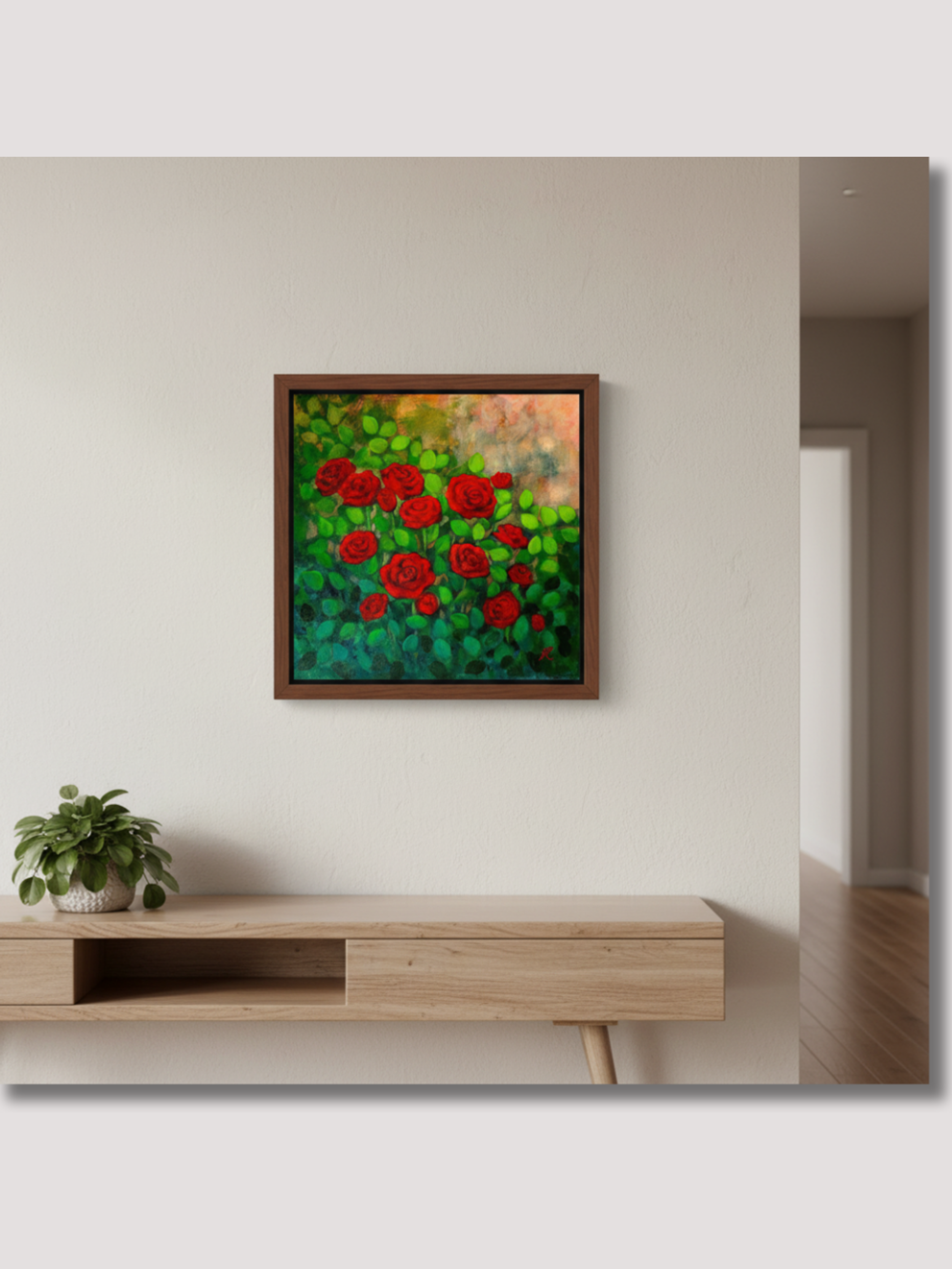 brown framed acrylic painting of red roses, hanging on a wall above a table
