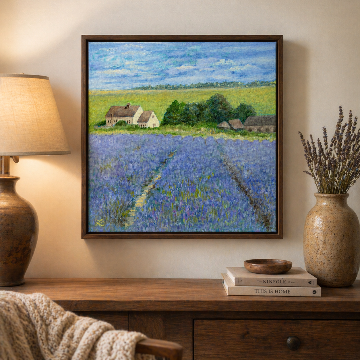 Framed oil painting of lavender fields leading to a country home, hanging on a wall in a home