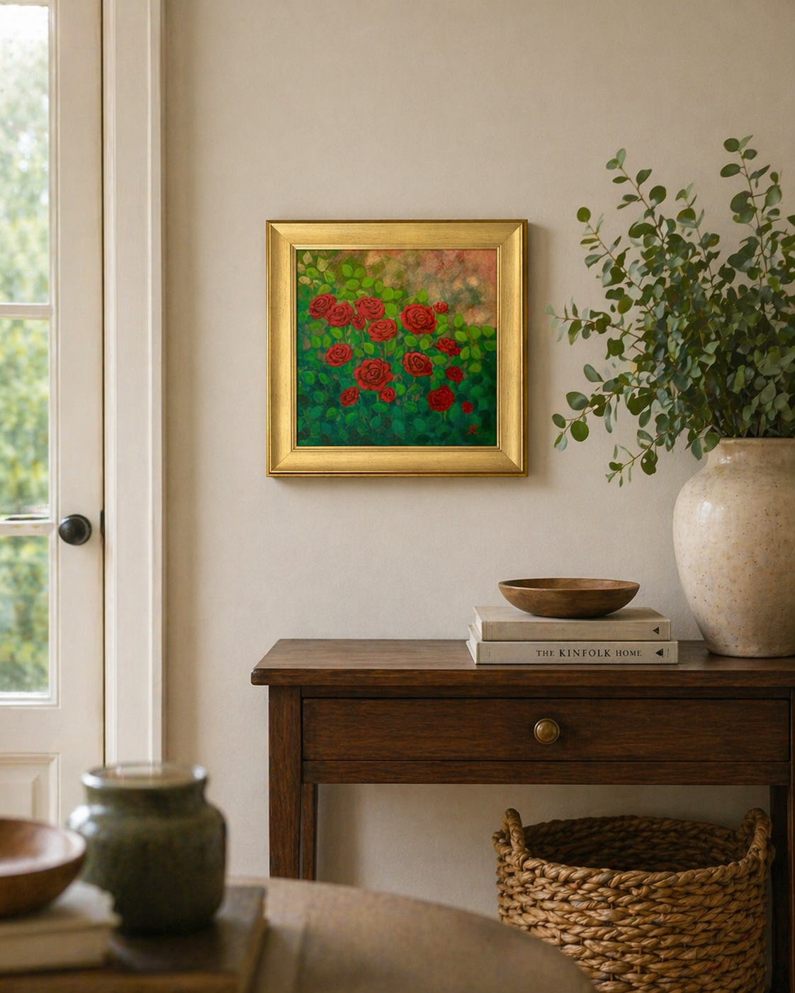 gold framed acrylic painting of red roses hanging on a living room wall