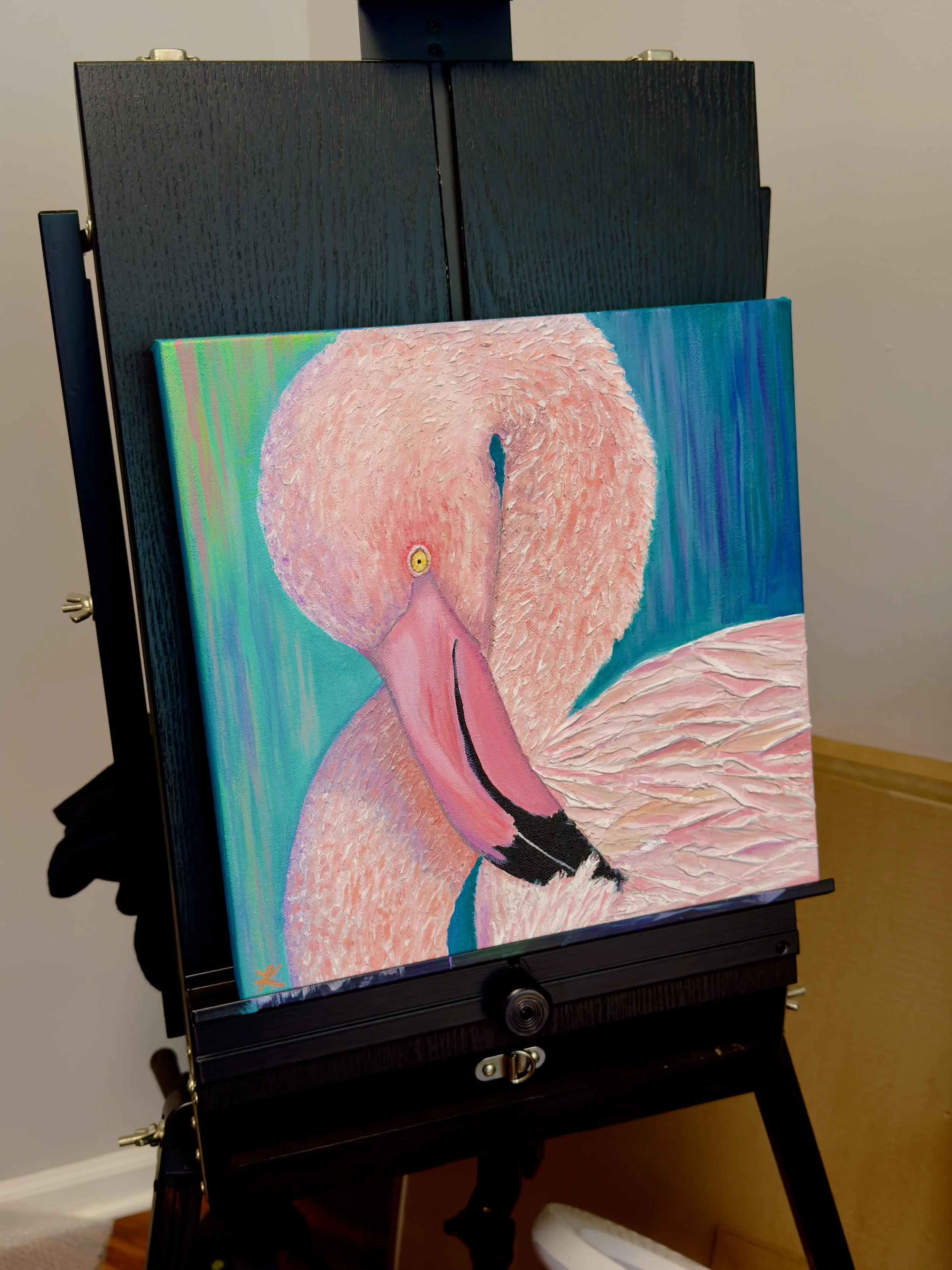 acrylic painting of a poised pink flamingo set on an easel