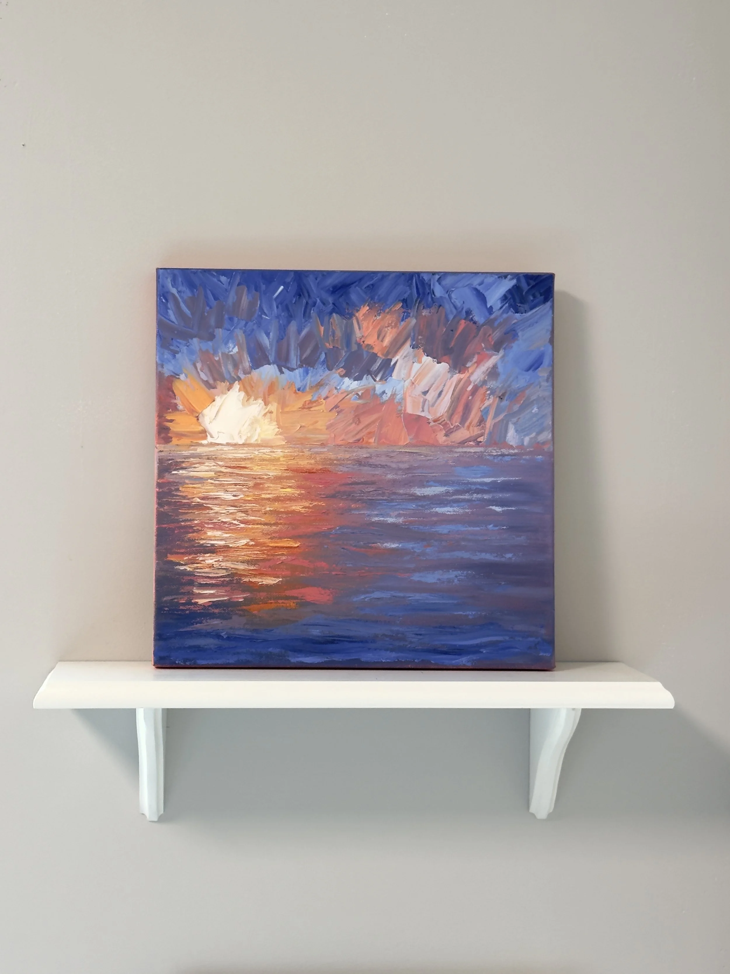 Impressionistic oil painting of a sunset over the ocean, set on a shelf